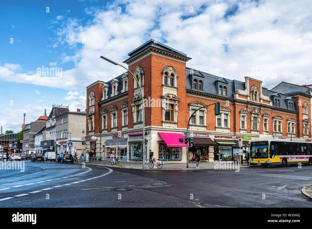 Historic red brick apartment & shop building on corner of Oberhofer Weg