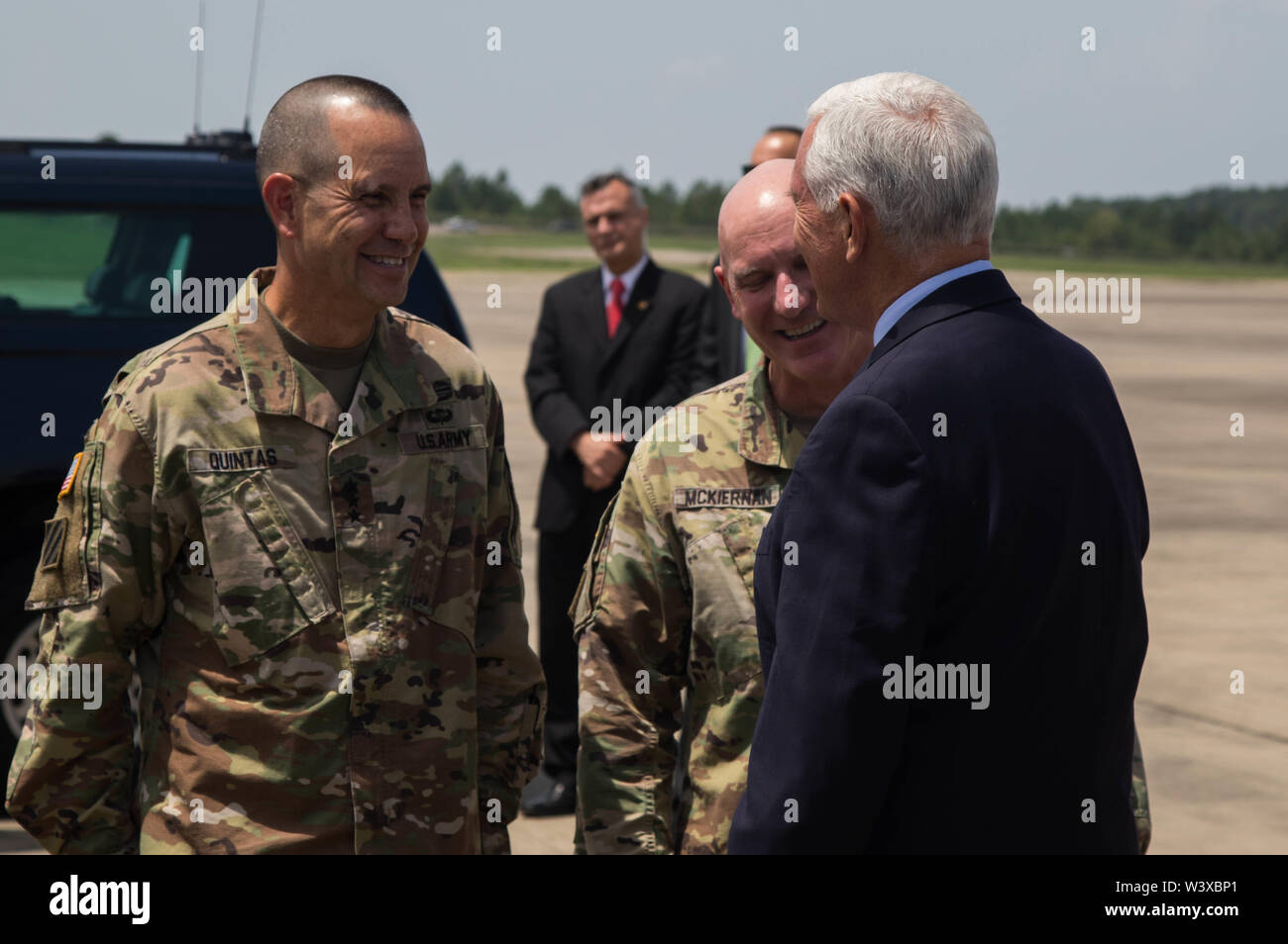 Vice President Mike Pence converses with Lieutenant General Leopoldo Quintas Jr., deputy commanding general, U.S. Army Forces Command, and Major General Brian McKiernan, deputy commanding general, XVIII Airborne Corps and Fort Bragg, at Pope Army Airfield on Fort Bragg, N.C. July 17, 2019. Pence was visiting Fort Bragg to speak at a Salute to the Troops ceremony. (U.S. Army Photo by Pfc. Joshua Cowden / 22nd Mobile Public Affairs Detachment) Stock Photo