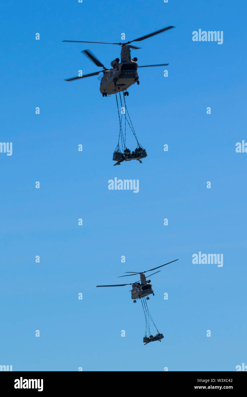Two U.S. Army CH-47 Chinook helicopters carry M777 155mm howitzer artillery pieces over Langham Beach, Queensland, Australia, July16, during Exercise Talisman Saber 2019. The purpose of Talisman Saber is to improve Australian-U.S. combat readiness and interoperability, maximize combined training opportunities, and conduct maritime prepositioning and logistics operations in maritime and littoral training areas of the Pacific. (U.S. Army Photo by Sgt. 1st Class Whitney C. Houston) Stock Photo