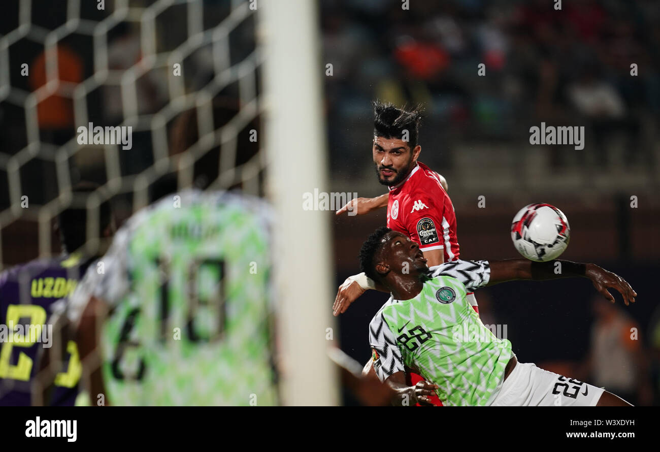 Cairo, Tunisia, Egypt. 17th July, 2019. FRANCE OUT July 17, 2019: Ferjani Sassi of Tunisia and Kenneth Josiah omeruo of Nigeria challenging for the ball during the 2019 African Cup of Nations match between Tunisia and Nigeria at the Al Salam Stadium in Cairo, Egypt. Ulrik Pedersen/CSM/Alamy Live News Stock Photo
