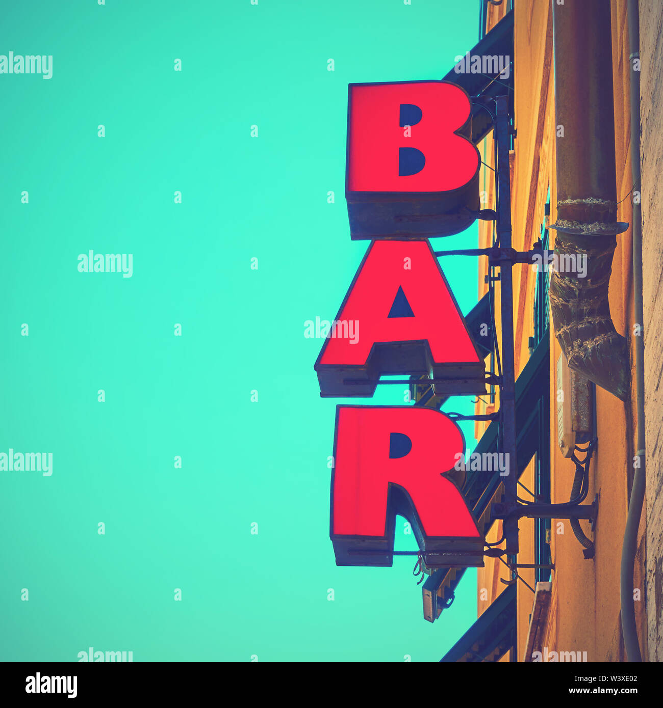 Red bar sign on the wall close-up. Social media style filtered Stock Photo