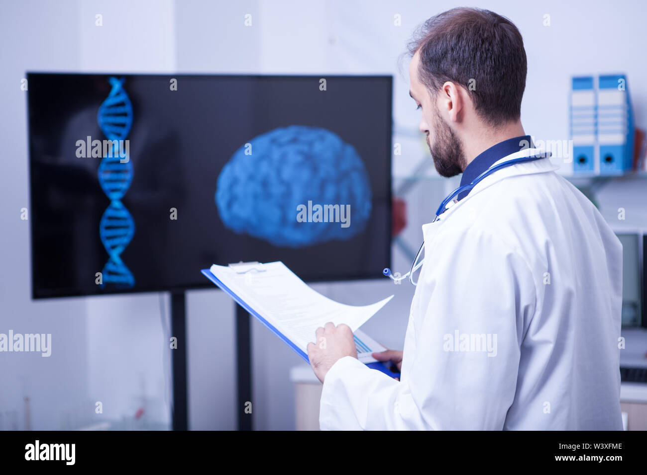 Specialist doctor in a laboratory looking at the scan of a brain ...
