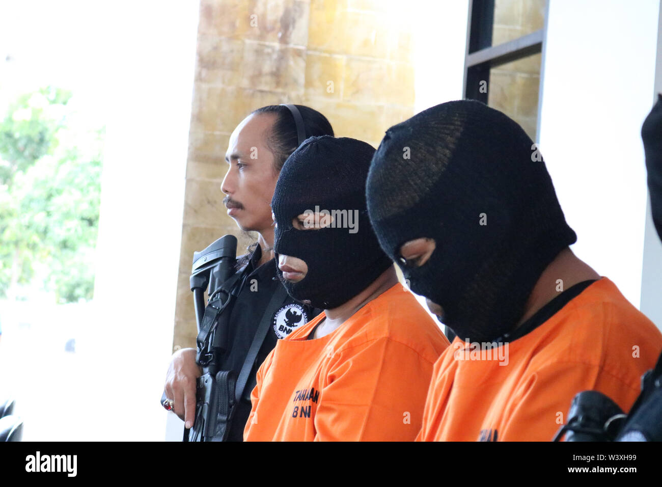 Makassar, Indonesia 18th July 2019, Two farmers who were drug dealers and money launders were wearing detention clothes when they were shown at a press conference at the National Narcotics Agency of the Republic of Indonesia. The two drug dealers were arrested in Sidrap Regency with cash and evidence worth 16 billion rupiah. Credit: Herwin Bahar / Alamy Live News Stock Photo