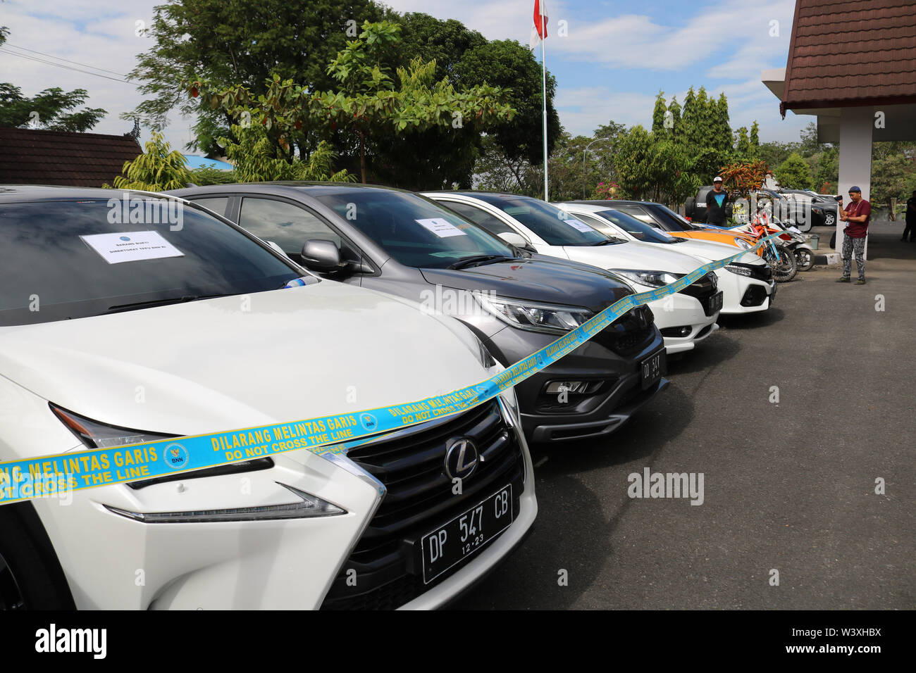 Makassar, Indonesia 18th July 2019, Evidence in the form of luxury cars resulting from the arrest of two farmers who became drug dealers and money laundering from Sidrap Regency was fitted with police lines by the National Narcotics Agency of the Republic of Indonesia. Credit: Herwin Bahar / Alamy Live News Stock Photo