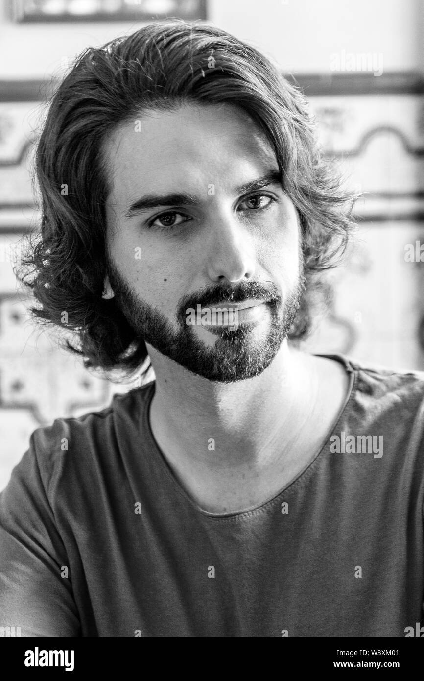 portraits of a young man on a terrace, looking at camera in black and white like the actors 40s 50s Stock Photo