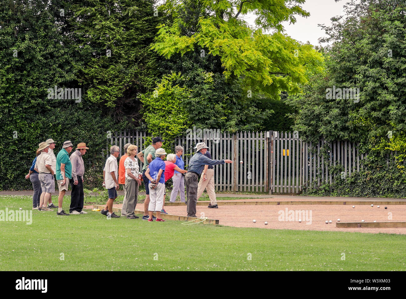 A mixed group of active pensioners keeping fit and healthy playing boules Stock Photo