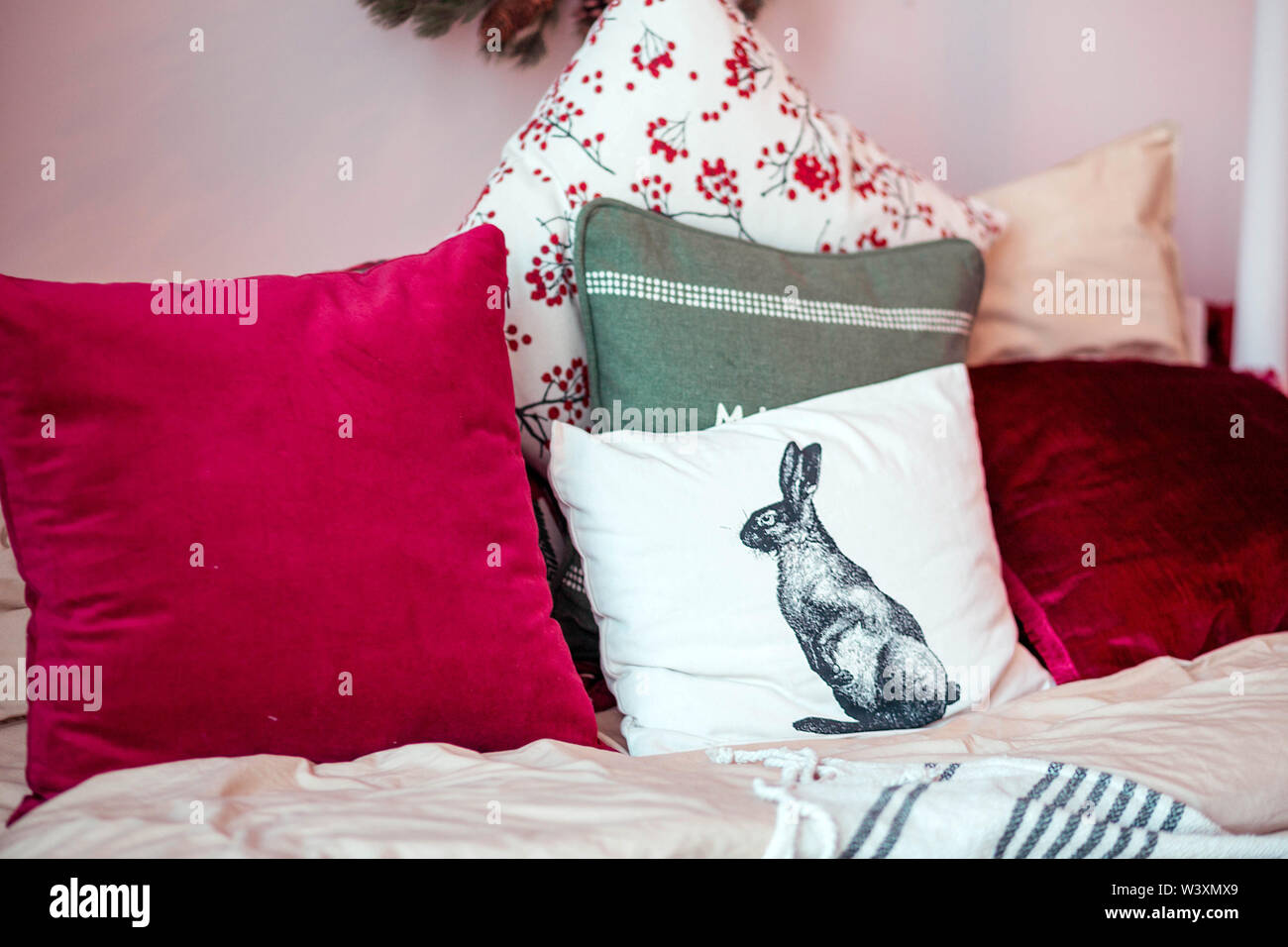 many different pillows lying on the bed Stock Photo