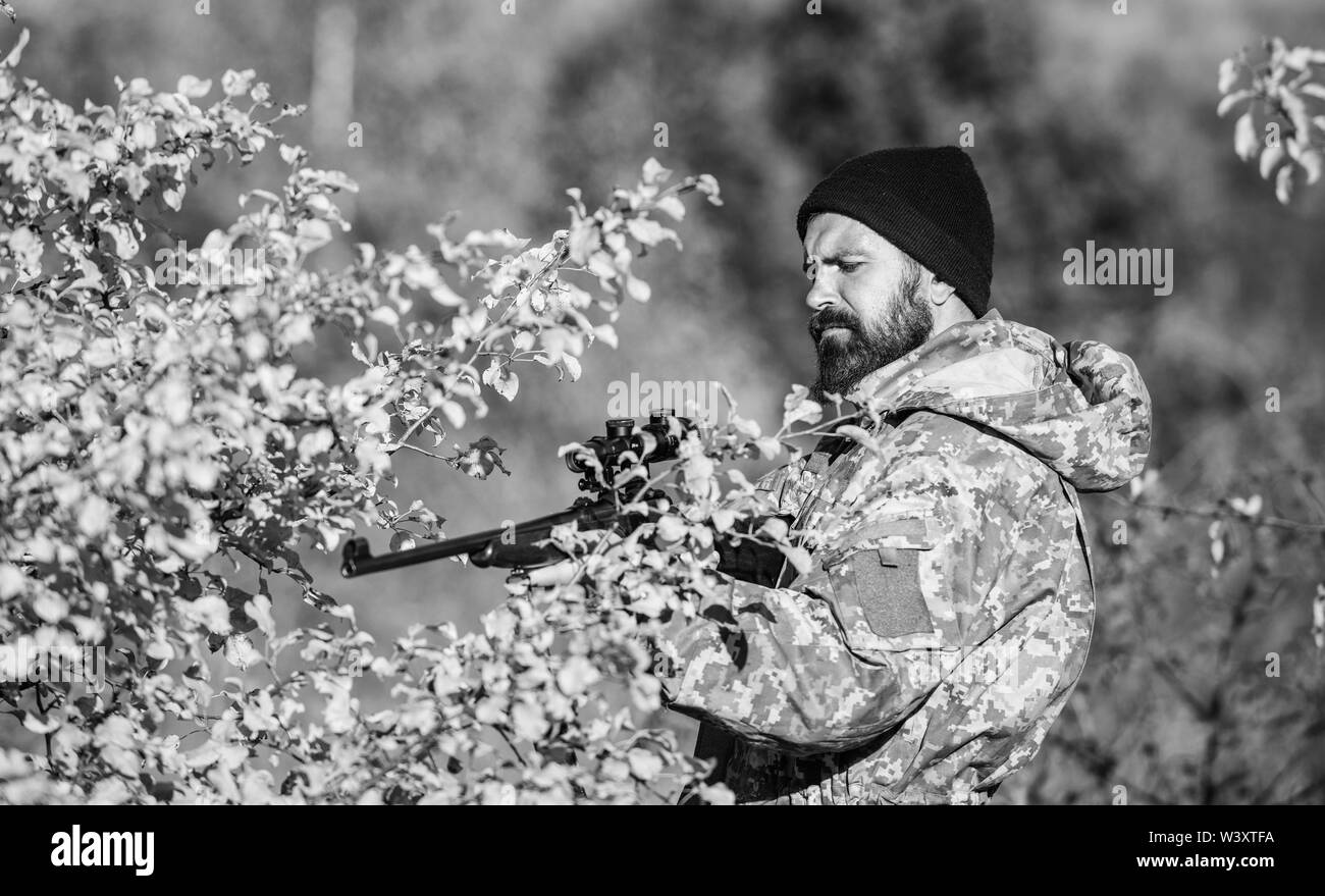 Man hunter with rifle gun. Boot camp. Military uniform fashion. Bearded man hunter. Army forces. Camouflage. Hunting skills and weapon equipment. How turn hunting into hobby. fight for freedom. Stock Photo
