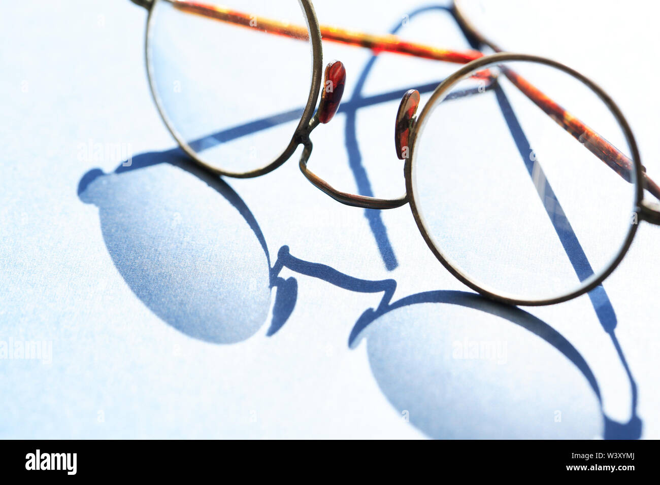 Old spectacles with shadow against sun light Stock Photo - Alamy