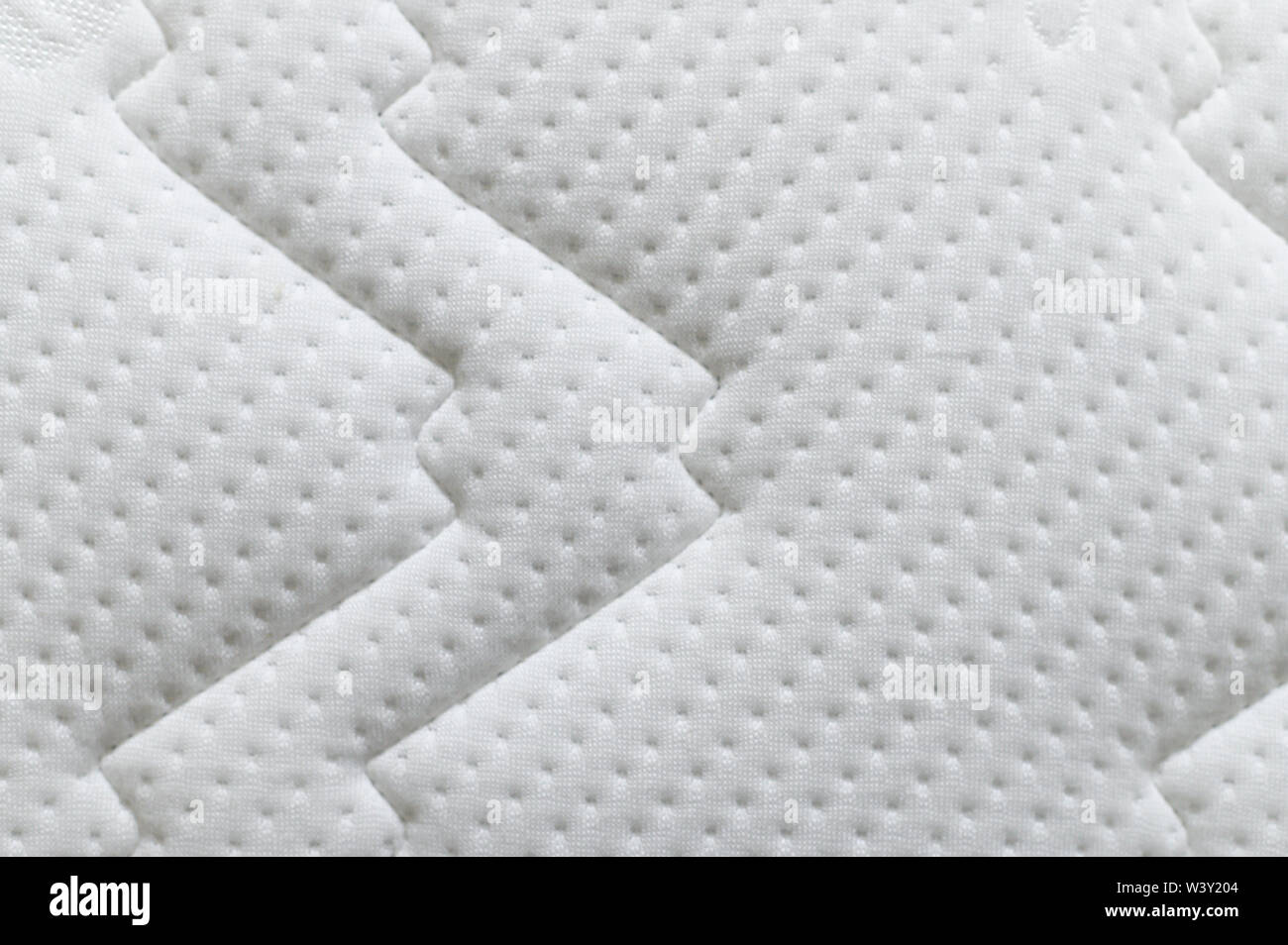 Closeup of white mattress texture background. Material and furniture concept. Comfortable soft couch bedding Stock Photo