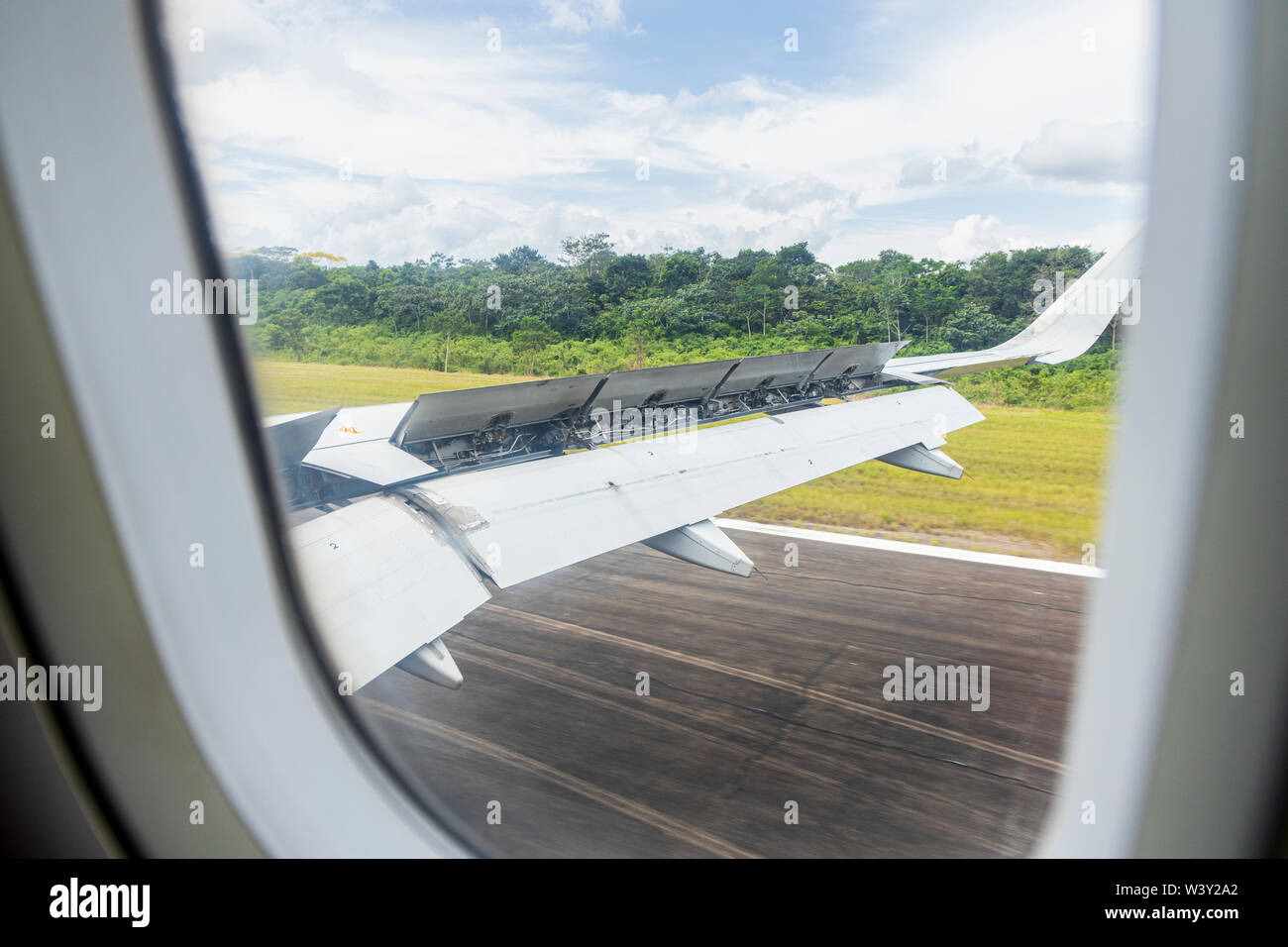 Passenger view of the flaps up for braking as a Airbus A320 lands on the runway at Puerto Maldonado airport in Peru, South America Stock Photo