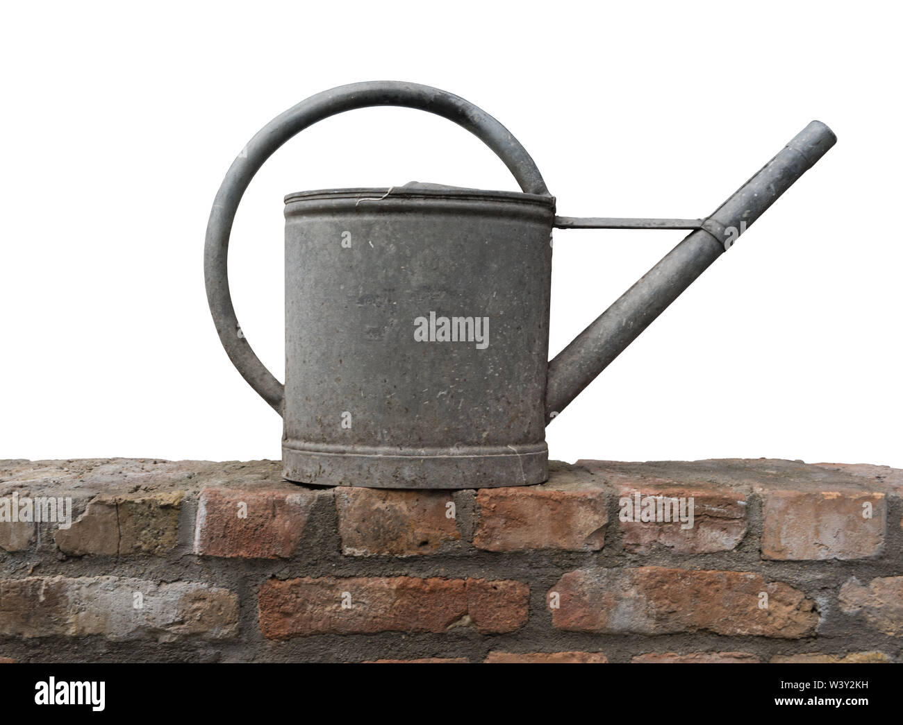 Old zinc watering can on a brick wall isolated Stock Photo Alamy