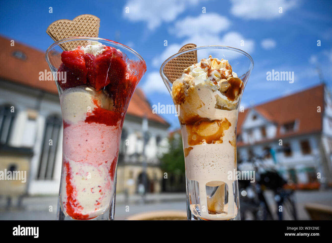 18 July 2019, Lower Saxony, Celle: Two sundaes are standing on a table in the market place in front of a blue sky. Photo: Christophe Gateau/dpa Stock Photo