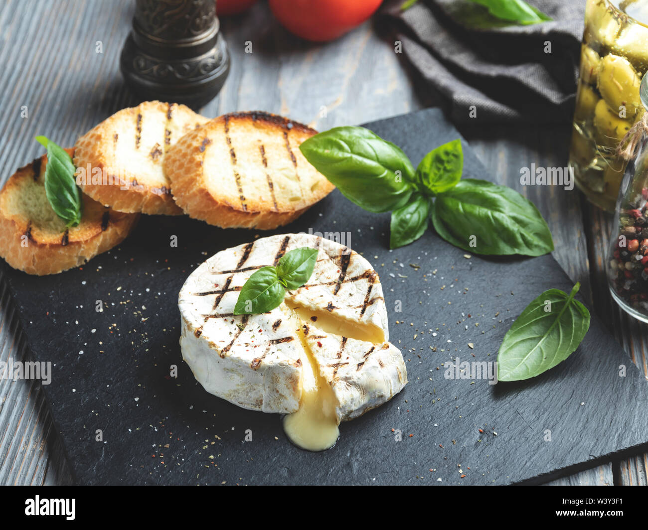 Camembert cheese grill ,on black stone background Stock Photo Alamy