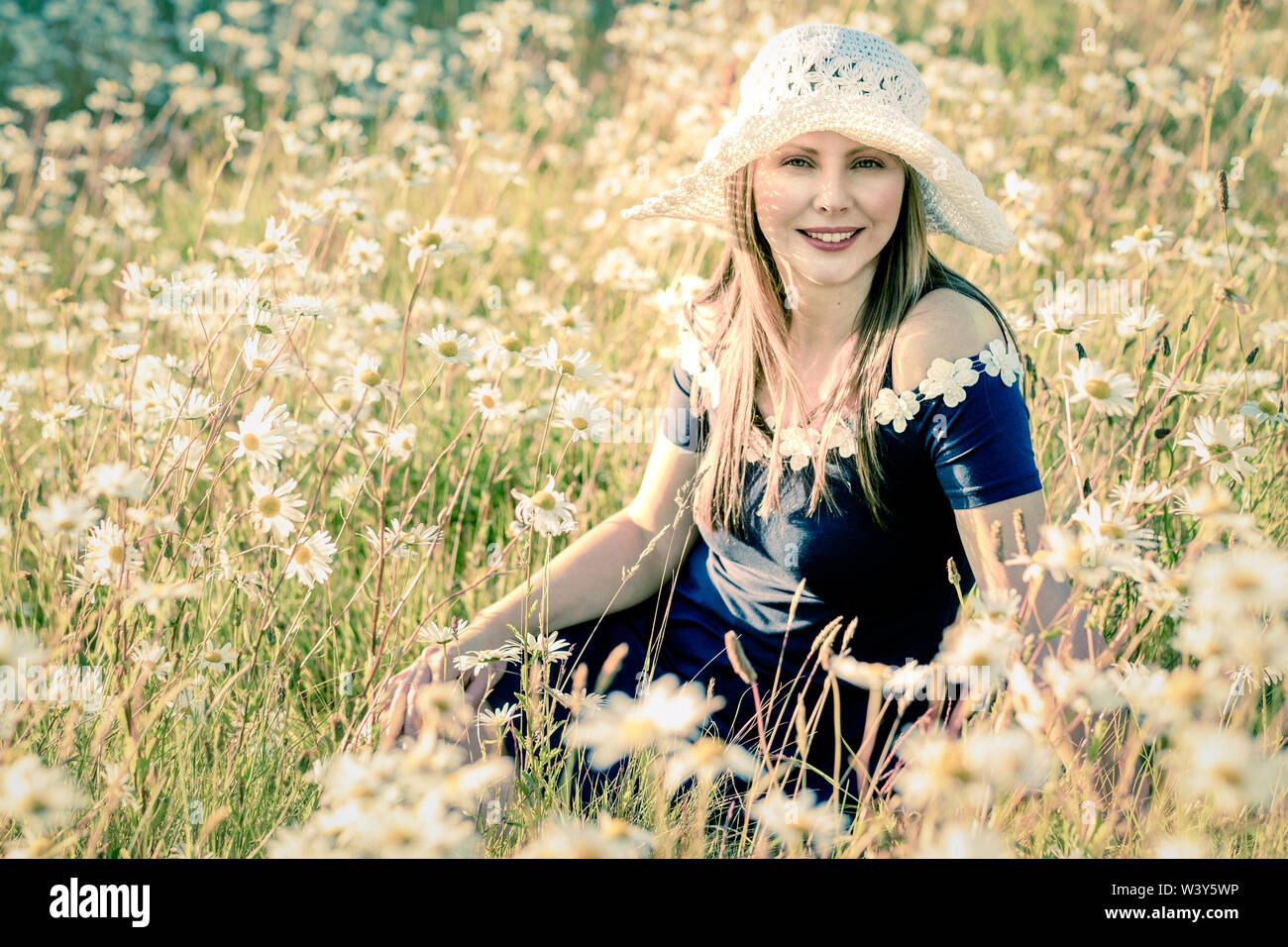 Lifestyle environmental portrait. Latvian model in field of flowers Stock Photo