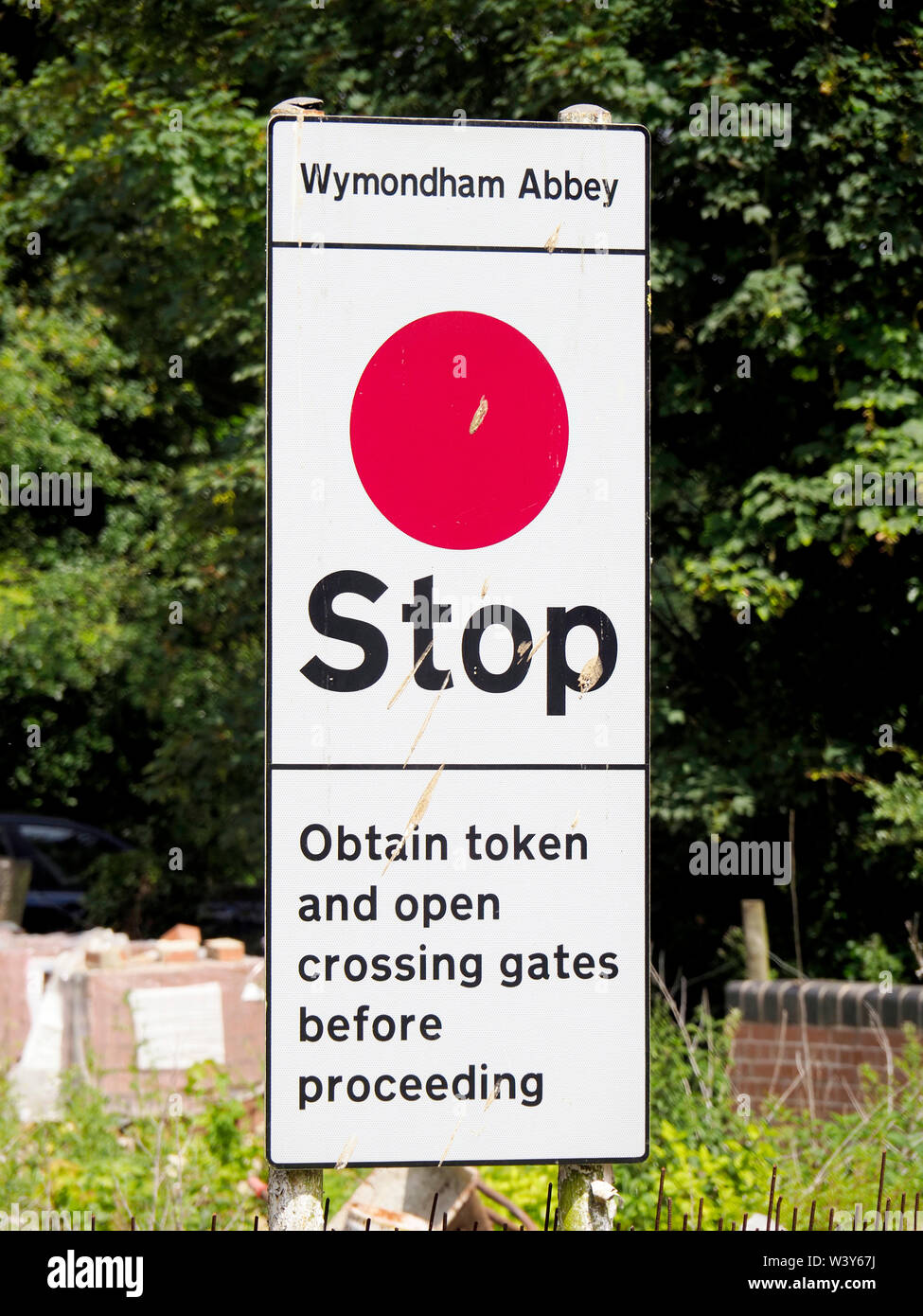 A modern railway safety sign warning trains to stop before proceeding onto the next section of track. Stock Photo