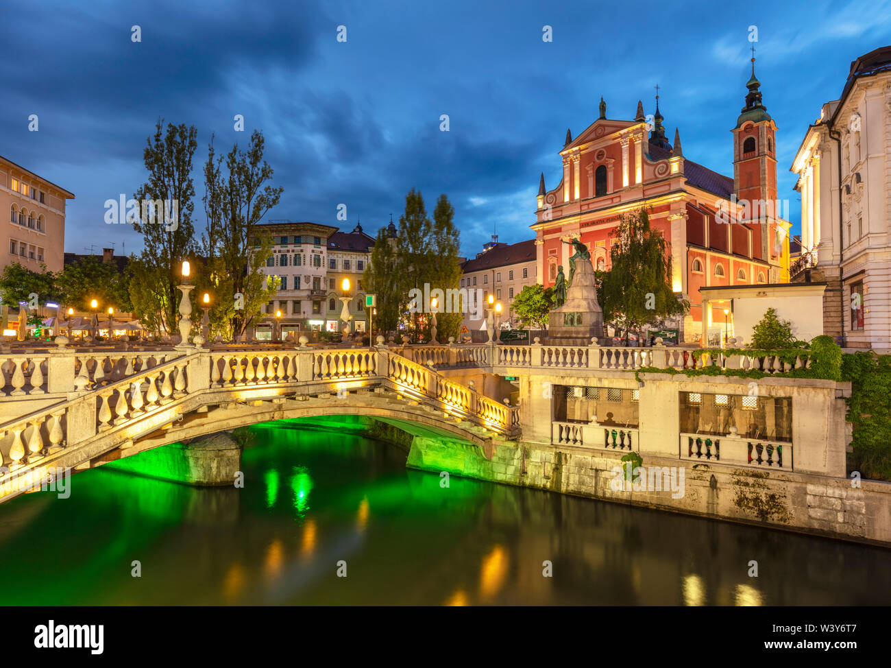 the Pink Franciscan Church  and the triple bridge  over river Ljubljanica river at night  ljubljana Slovenia EU Europ Stock Photo