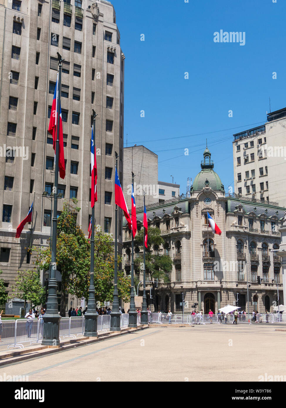 SANTIAGO DE CHILE, CHILE - JANUARY 26, 2018: Chilean flags waving in the Plaza de la Constitución, in the center of the city of Santiago de Chile, Chi Stock Photo
