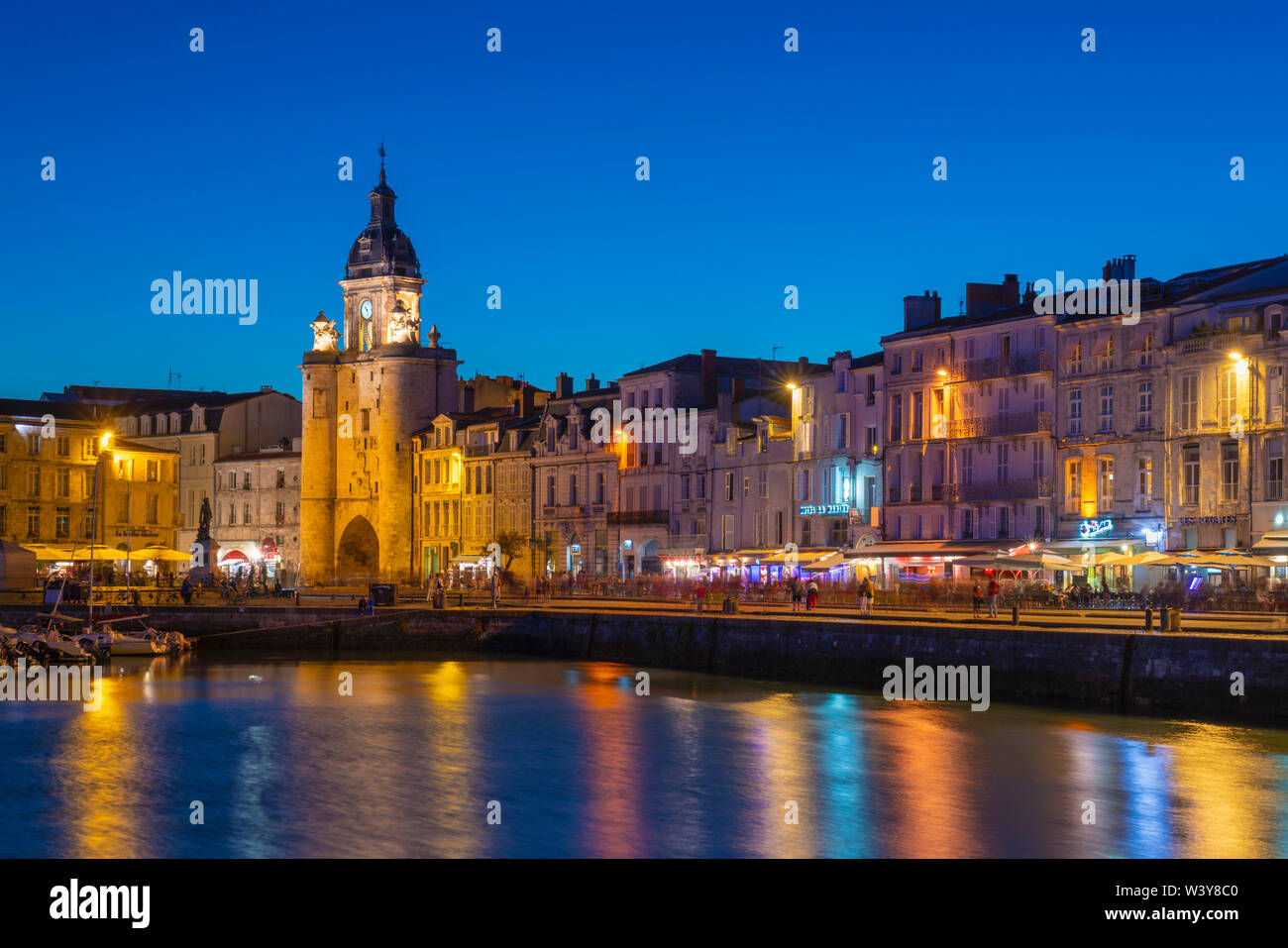 France, Poitou Charentes, La Rochelle, Old Harbour, Porte de La Grosse Horloge at dusk Stock Photo