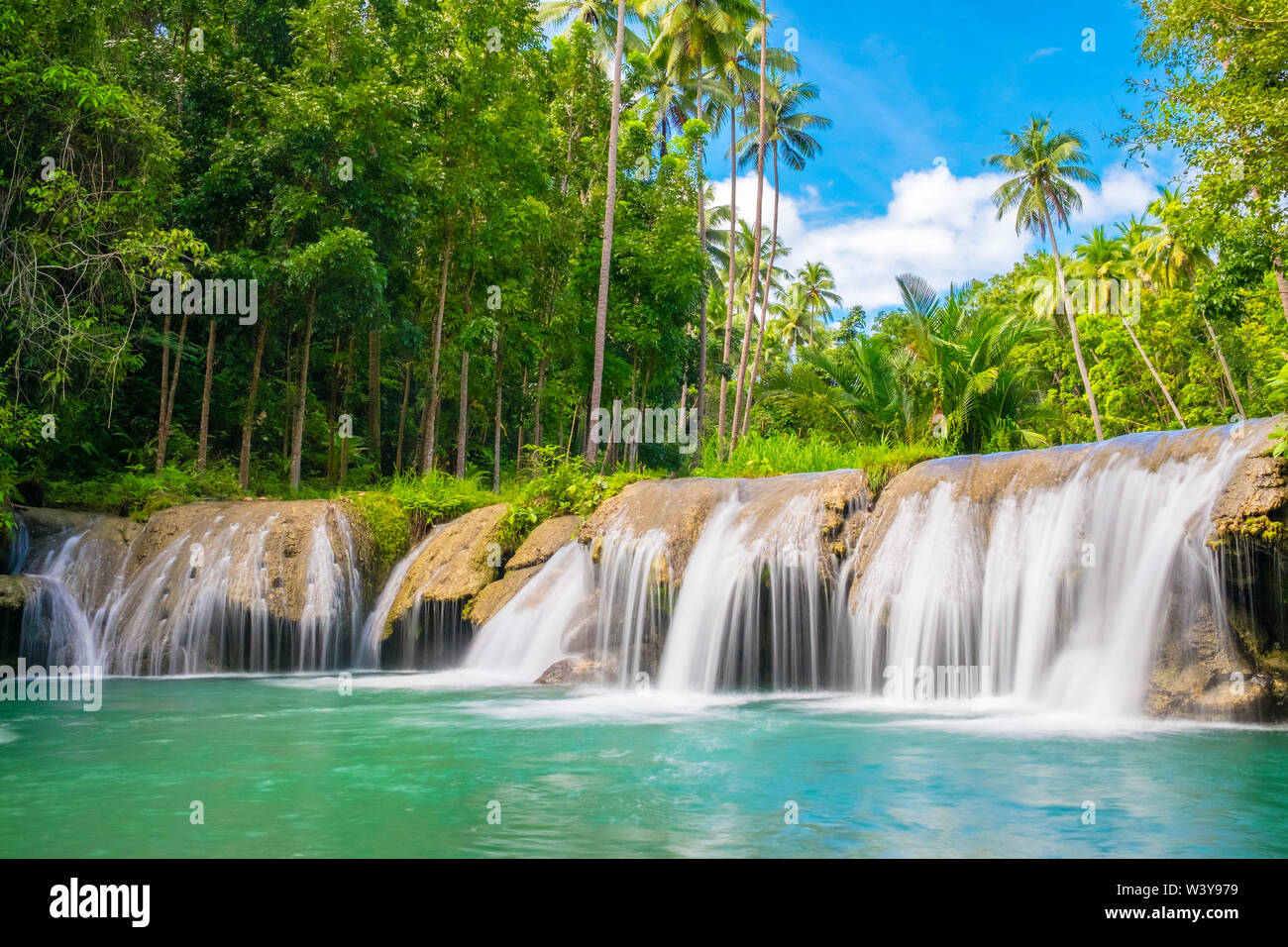 Cambugahay Falls surrounded bu jungle foliage, Lazi, Siquijor Island, Central Visayas, Philippines Stock Photo