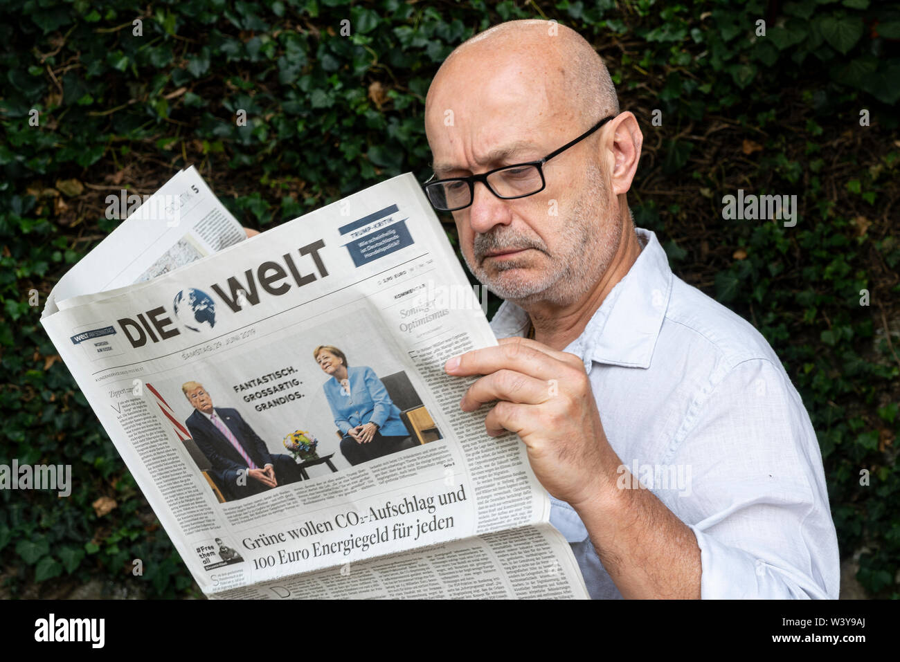 Frankfurt am Main, Germany. June 29, 2019. A man reads the Die Welt  german newspaper Stock Photo