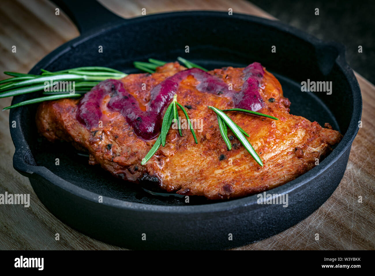 Fried chicken fillet in a paprika marinade with wild berry sauce and a