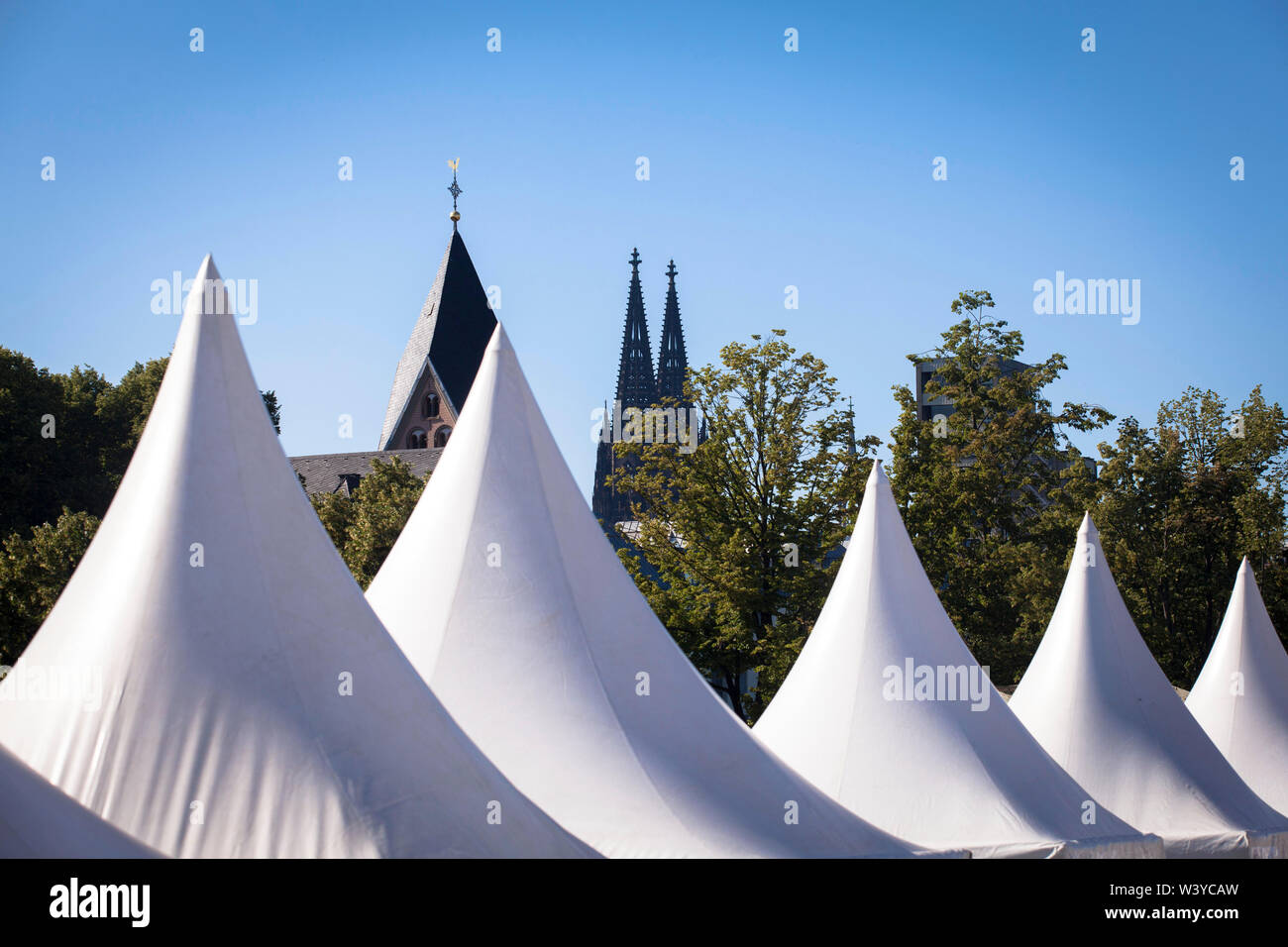 pagoda tents of the wine festival in the Rheinau harbor, church St. Maria in Lyskirchen and the cathedral, Cologne, Germany.  Pagodenzelte, Weinfest i Stock Photo