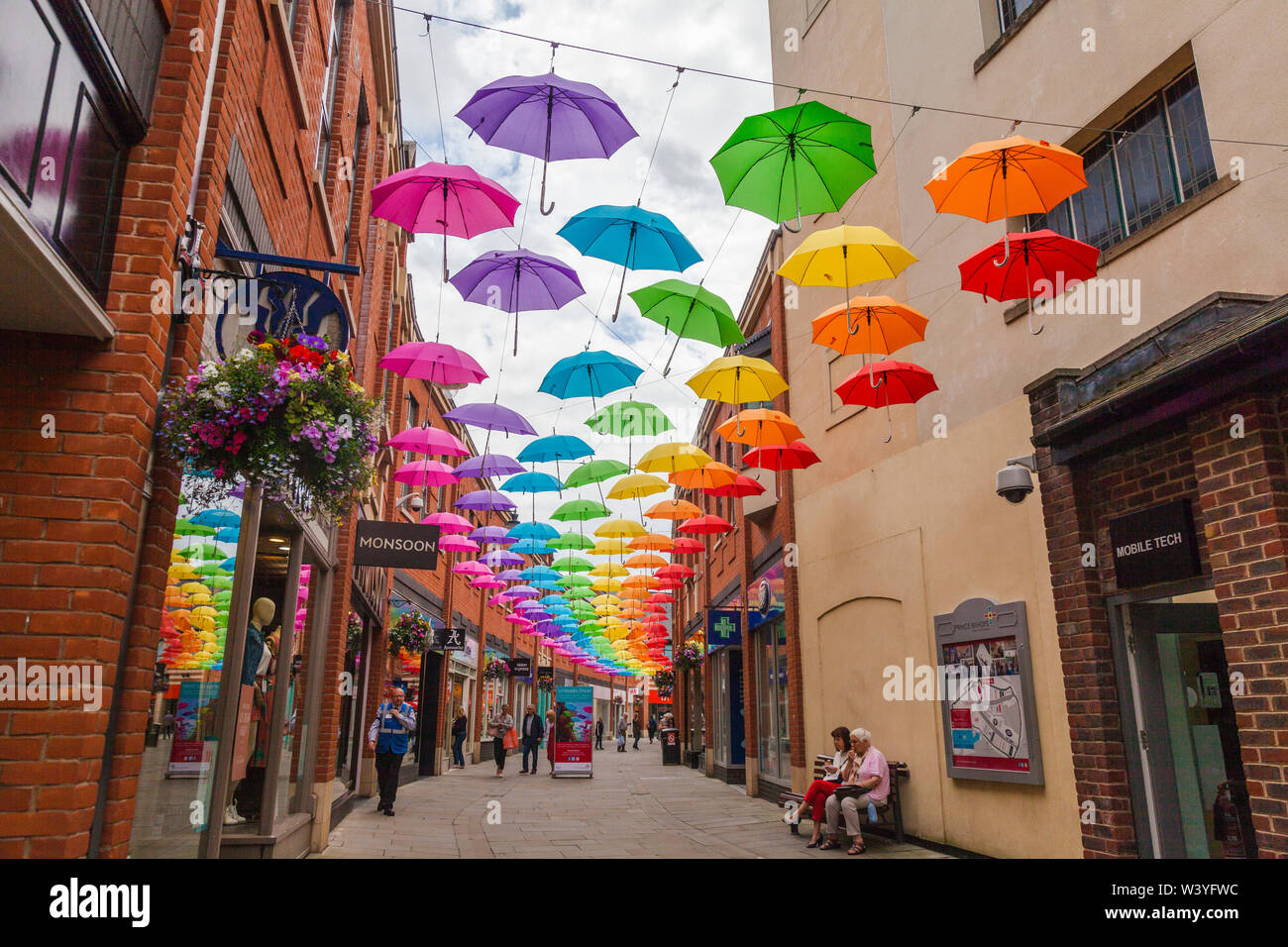 A colourful display of umbrellas hanging overhead in the shopping precinct  in Durham,England,UK Stock Photo - Alamy