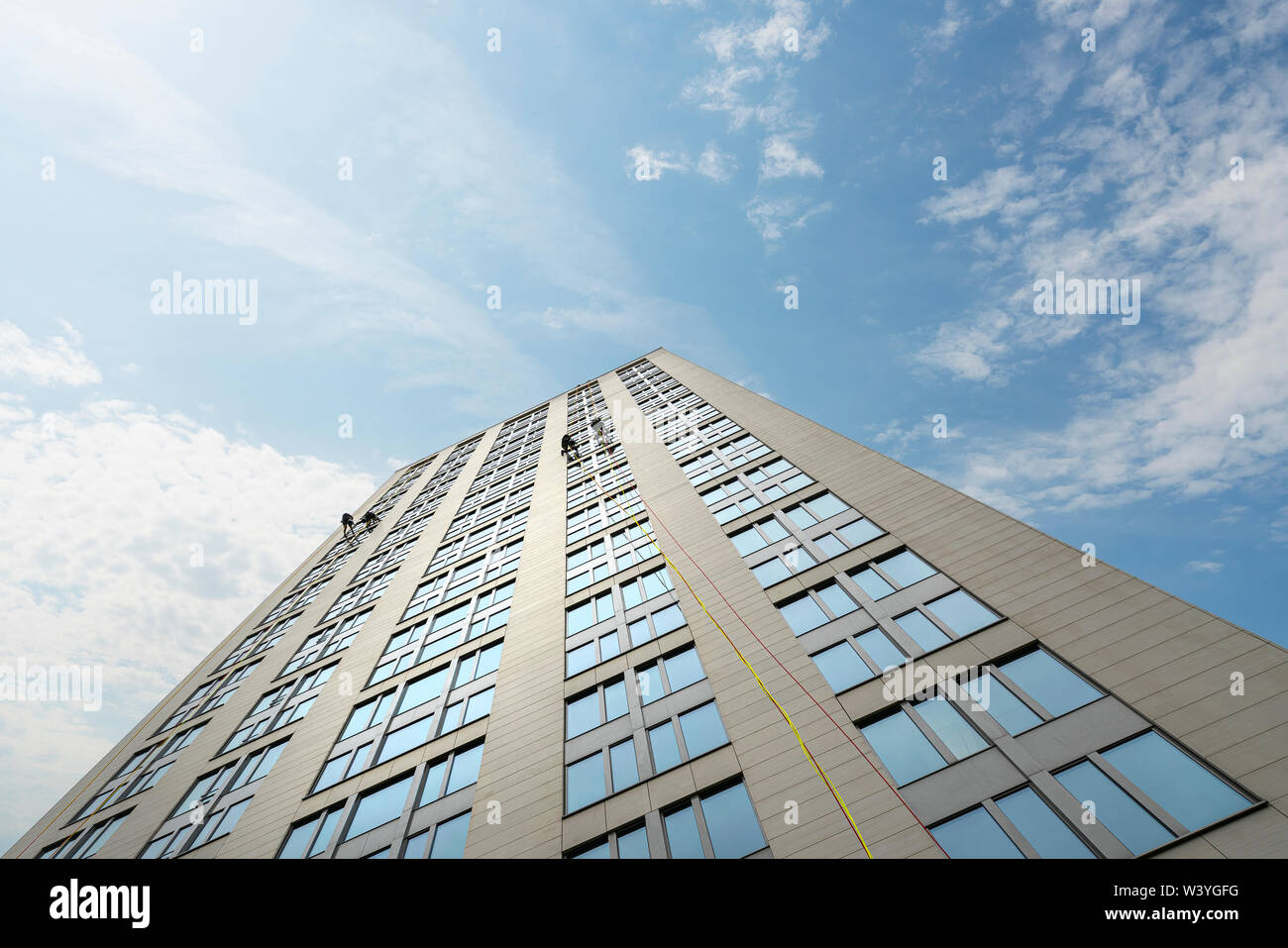 Frankfurt am Main, July 2019.  some window cleaner workers hanging with rope on a skyscraper Stock Photo