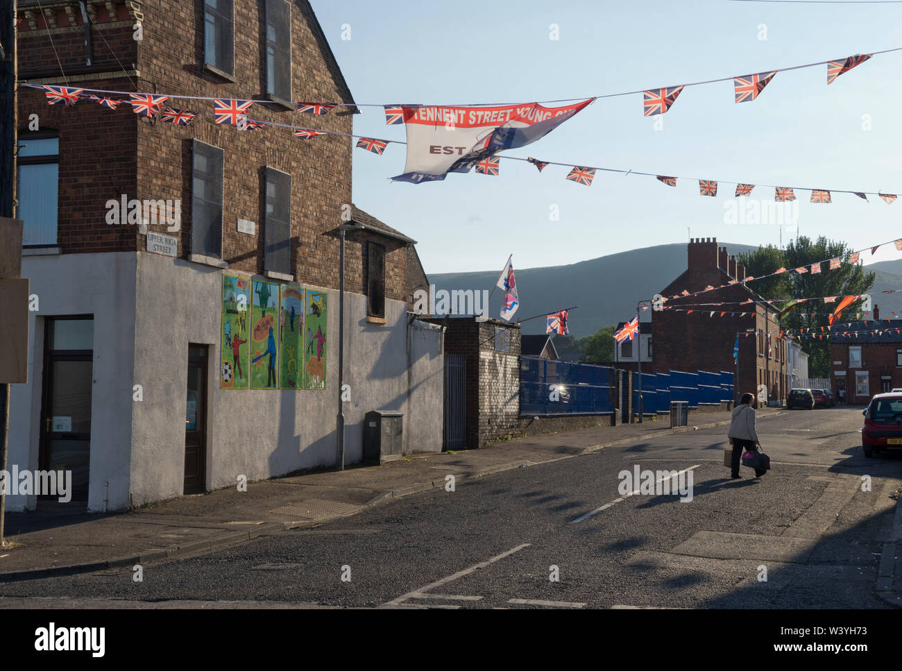 Loyalist flags and Tennent Street Young Guns gang banners in the Shankhill area of Belfast ,Northern Ireland Stock Photo