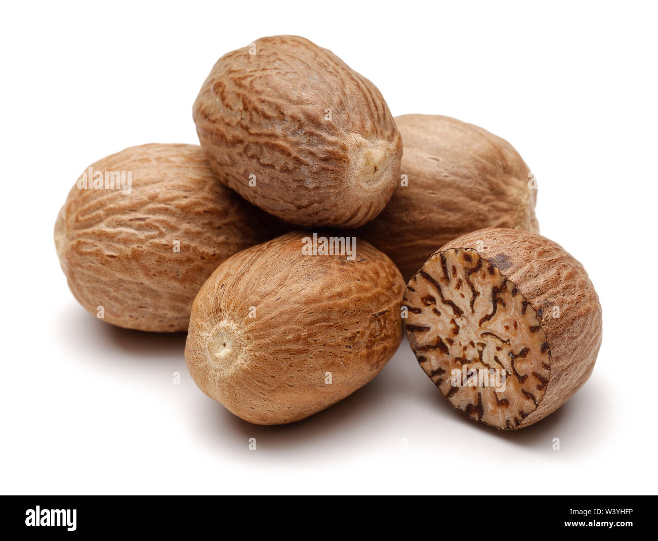 Whole and half nutmeg isolated on white background Stock Photo Alamy