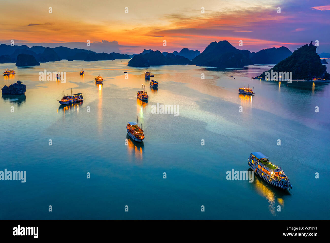 Aerial view of sunset, dawn near Ti Top rock island, Halong Bay, Vietnam, Southeast Asia. UNESCO World Heritage Site. Junk boat cruise to Ha Long Bay. Stock Photo