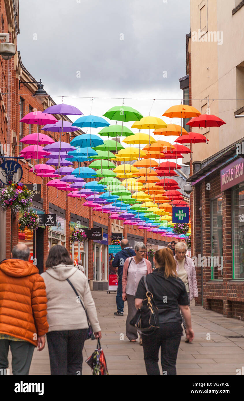 A colourful display of umbrellas hanging overhead in the Prince shopping precinct in