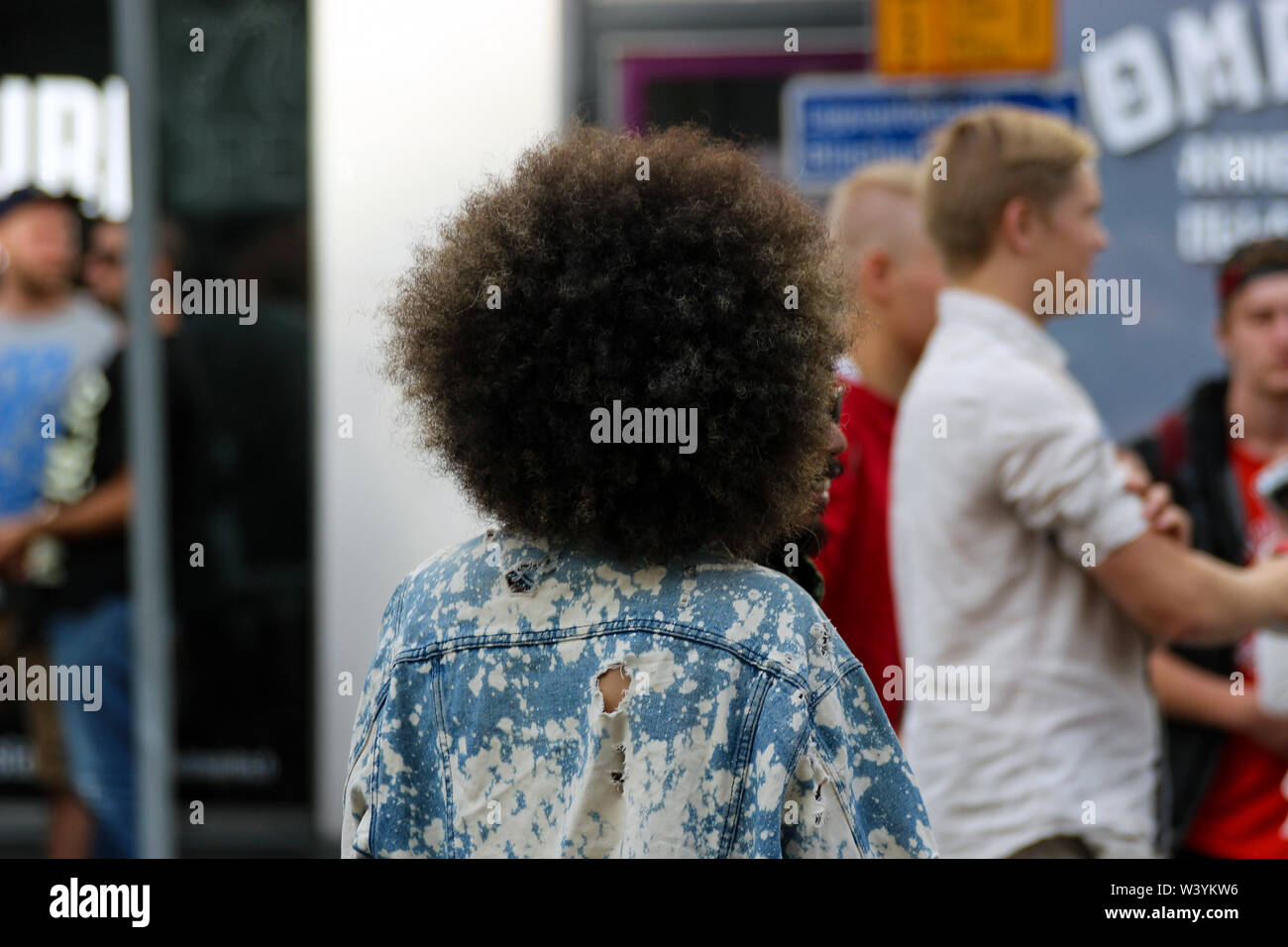 Candid rear view shot of woman with afro at Kallio Block Party 2016 in Helsinki, Finland Stock Photo