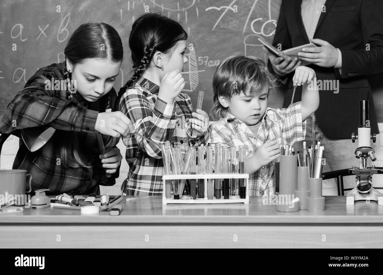 chemistry lab. back to school. happy children teacher. kids in lab coat