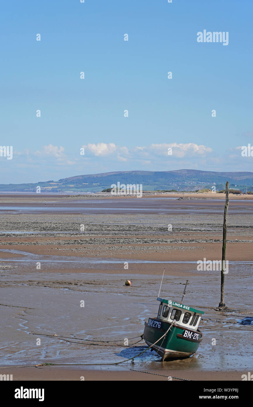 A boat moored in the small harbour at low tide at Minehead, Somerset ...