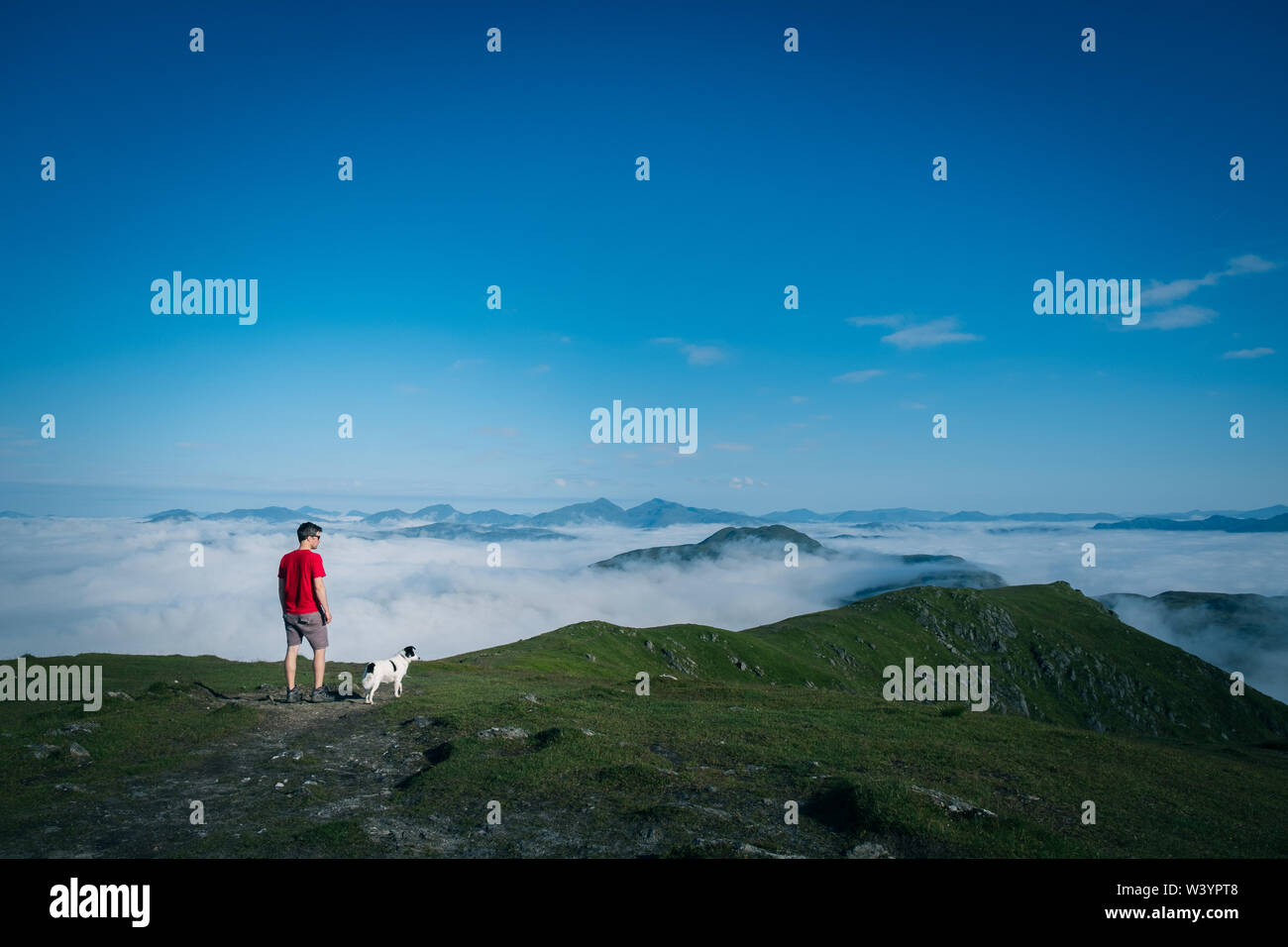 Man with dog Summit of Ben Ledi, Scotland Stock Photo