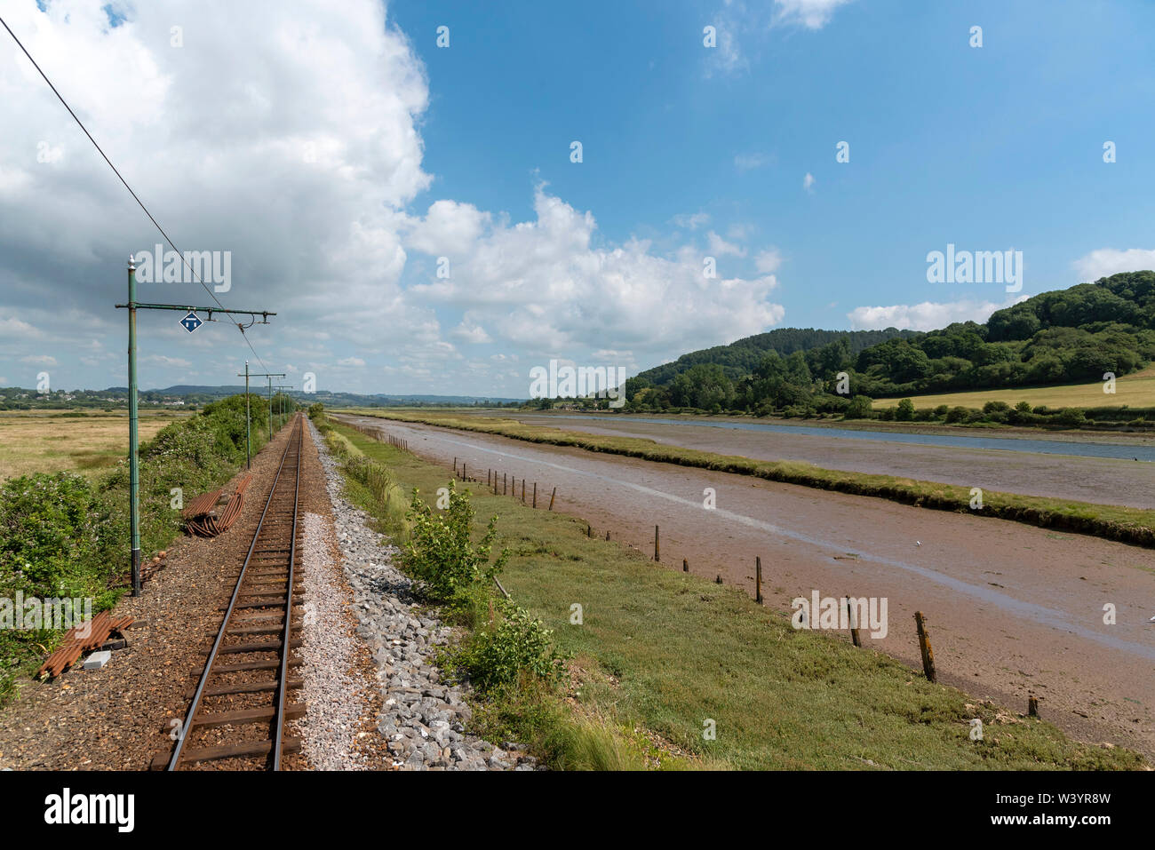 Seaton, Devon, England, UK. July 2019. Tramway tracks run alongside the River Axe at low tide