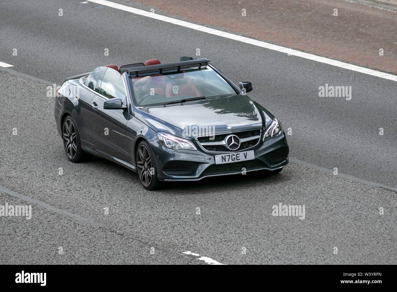 2015 Mercedes-Benz E220 AMG Line Bluetec AUT; UK Vehicular traffic, transport, with private number plate, personalised, cherished, dateless, DVLA registration marks, registrations,modern saloon cars, south-bound on the 3 lane M6 motorway highway. Stock Photo