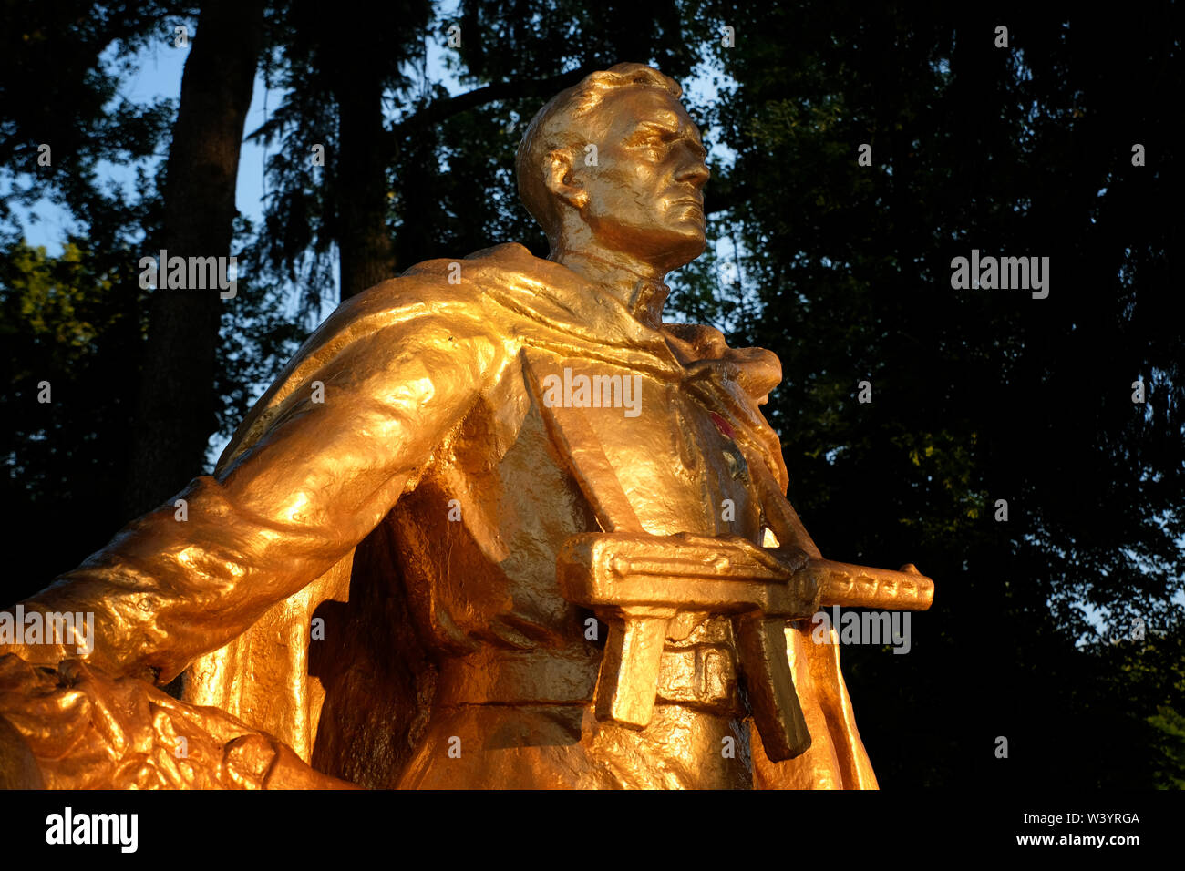 A gilded sculpture of a warrior-machine gunner at the monument complex to Peter Barbashov Hero of the Soviet Union located on the route Vladikavkaz - Alagir, near the village of Gizel in the Republic of North Ossetia-Alania the North Caucasian Federal District of Russia. Stock Photo