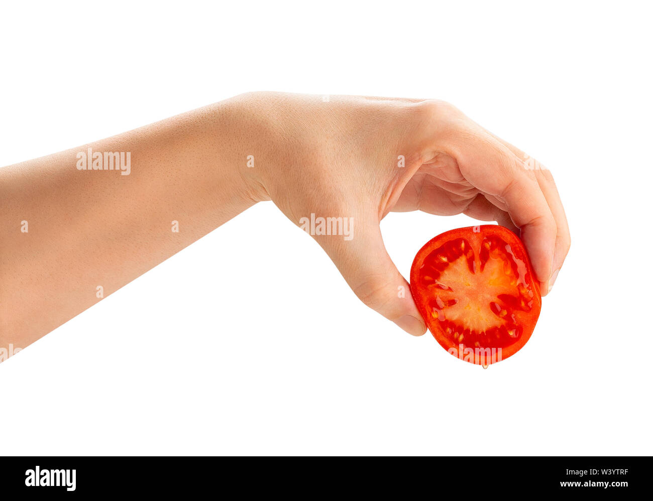 sliced tomato in squeezing hand path isolated on white Stock Photo