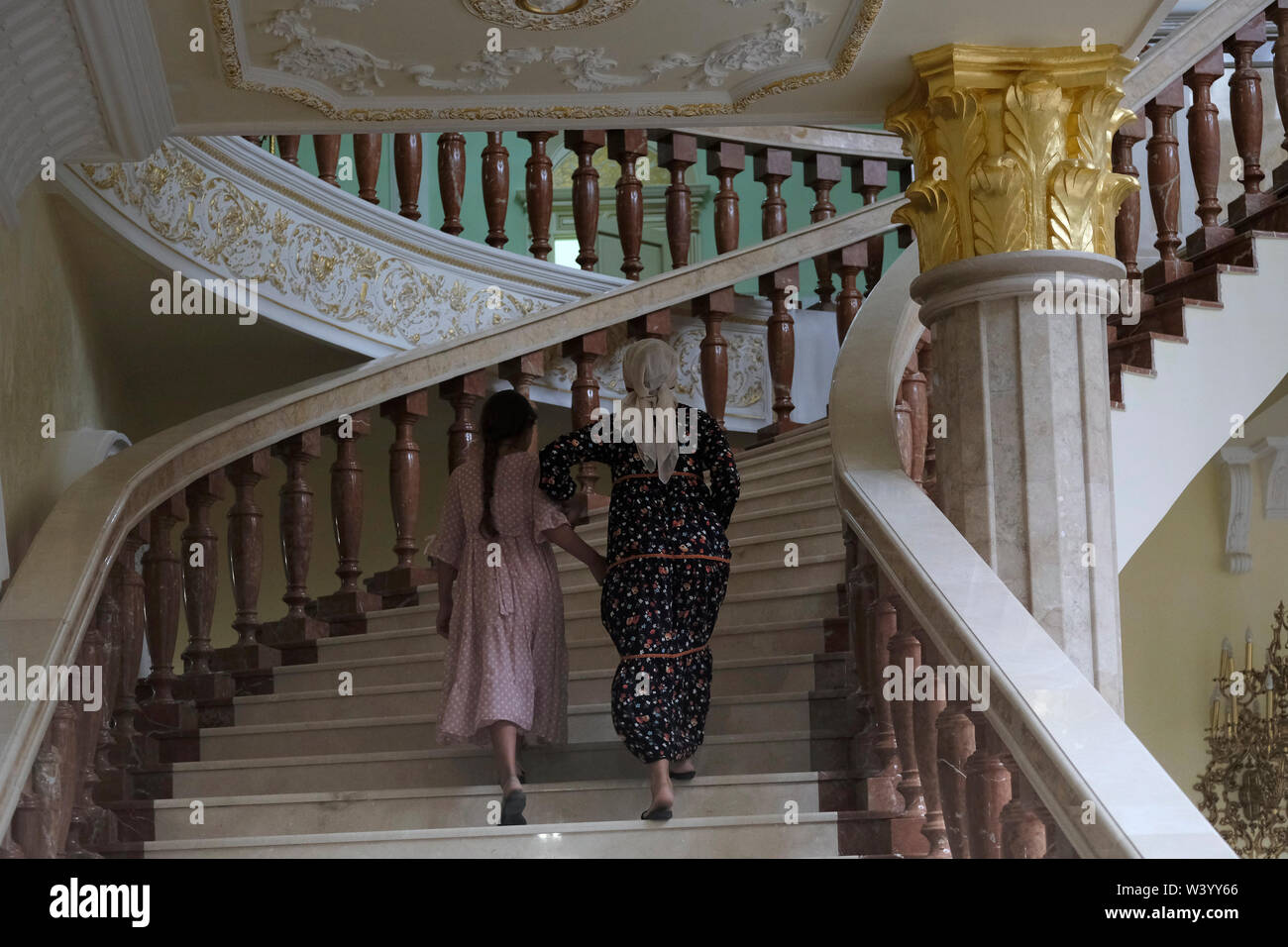 Local visitors climb the stairs inside Akhmat Kadyrov museum overwhelmingly a shrine to Akhmat and Ramzan Kadyrov in Grozny the capital city of Chechnya in the North Caucasian Federal District of Russia. Stock Photo