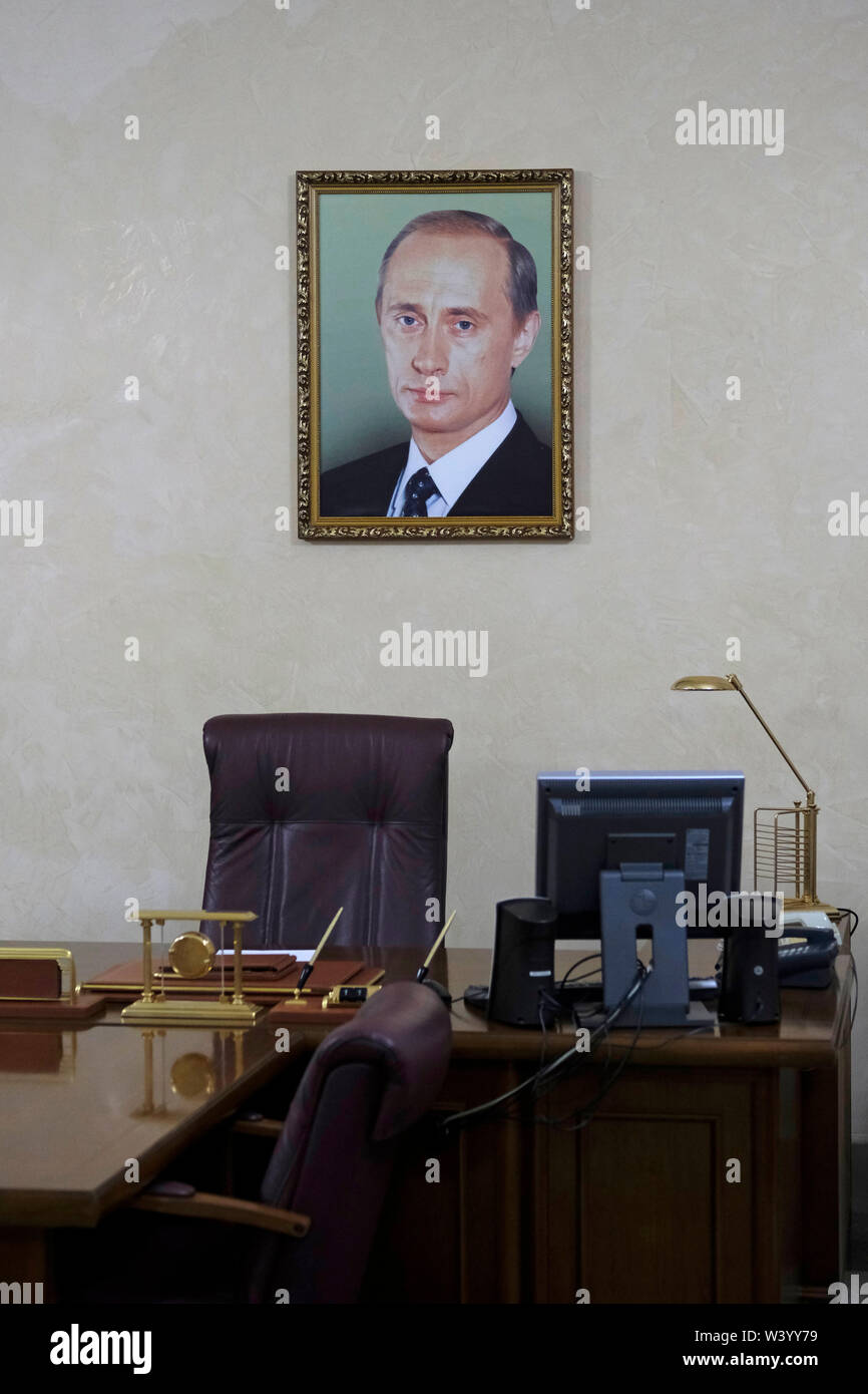 An exact recreation of Akhmat Kadyrov office (former Head of the Chechen Republic) with the portrait of Putin that he supposedly had hanging in his office displayed at Akhmat Kadyrov museum overwhelmingly a shrine to Akhmat and Ramzan Kadyrov in Grozny the capital city of Chechnya in the North Caucasian Federal District of Russia. Stock Photo