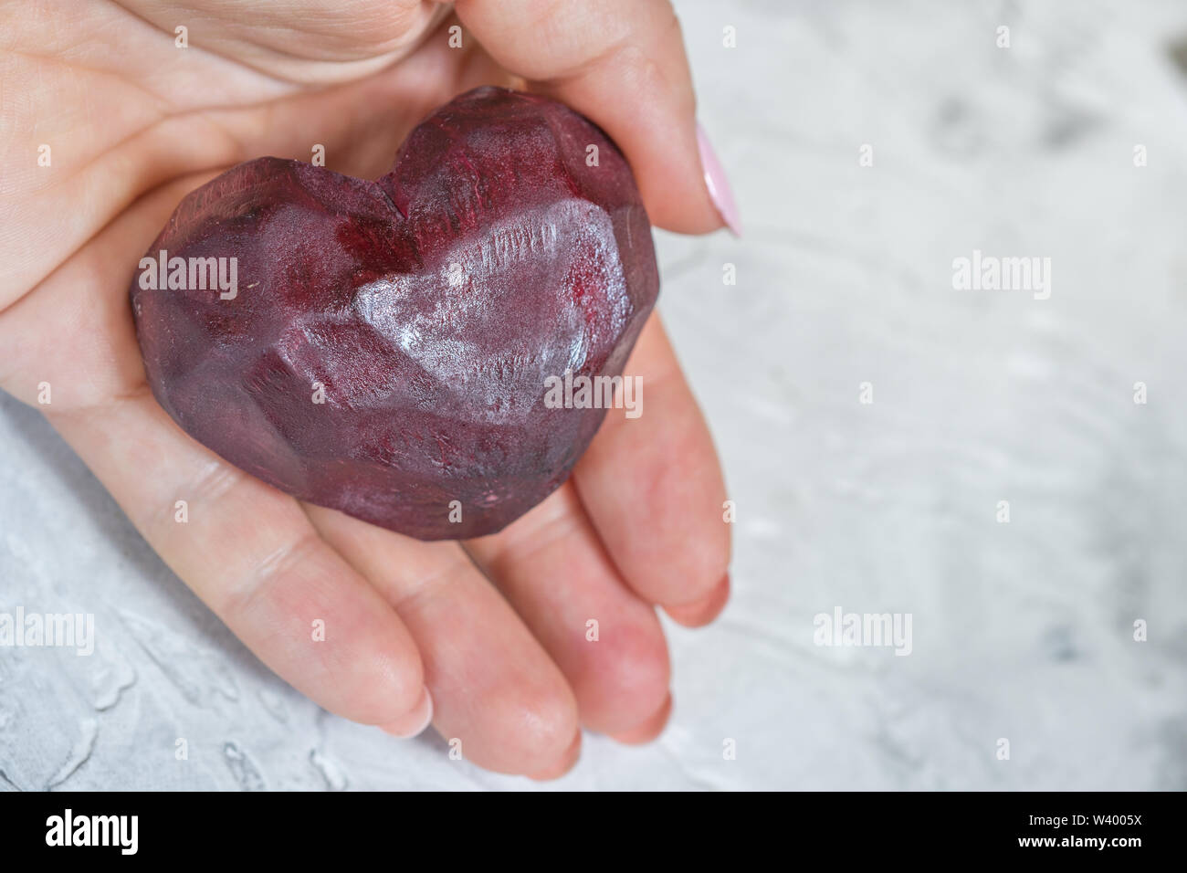 Beet heart in a hand Stock Photo - Alamy