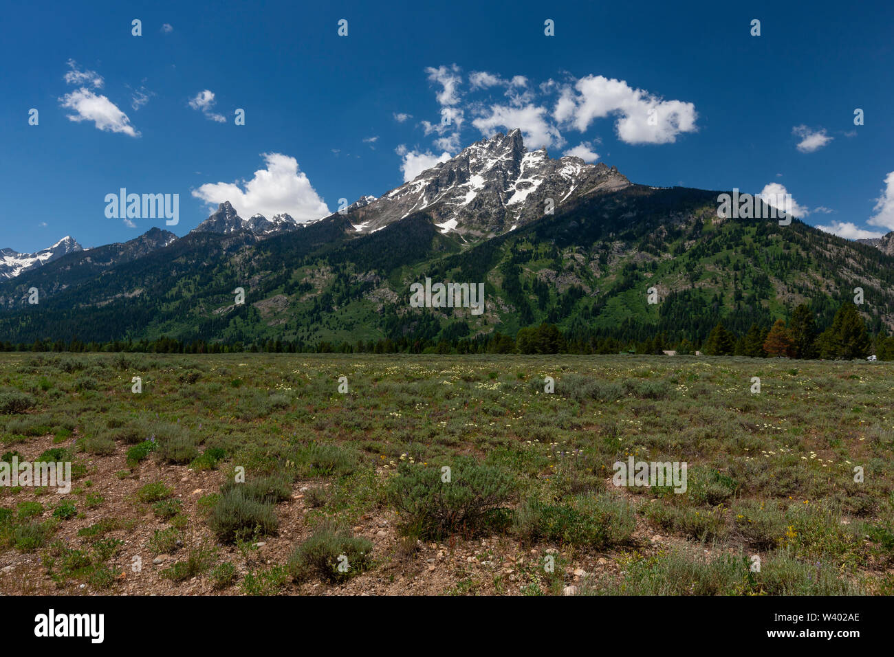 A mountain range in Montana with blue sky and clouds Stock Photo - Alamy