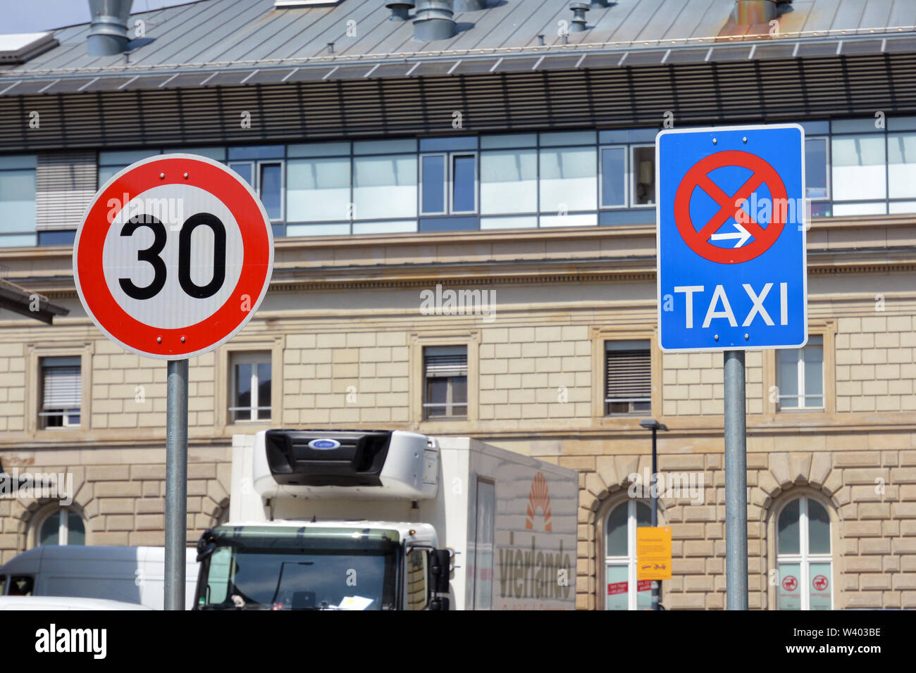 Mannheim, Germany - July 2019: 30kmh speed limit road sign and end of taxi rank parking road sign next to each Stock Photo