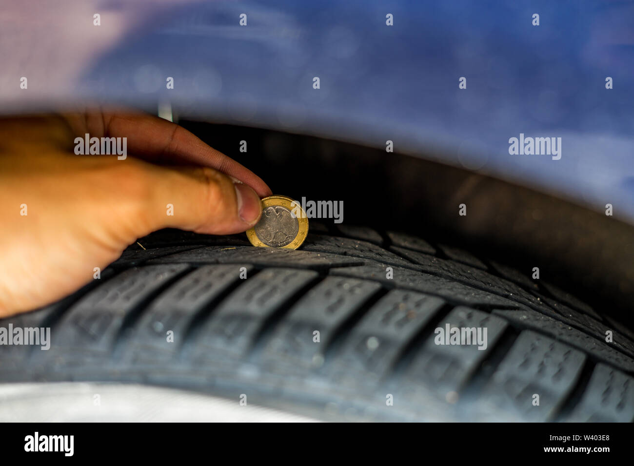 Control of the car tire profile with a one euro coin Stock Photo