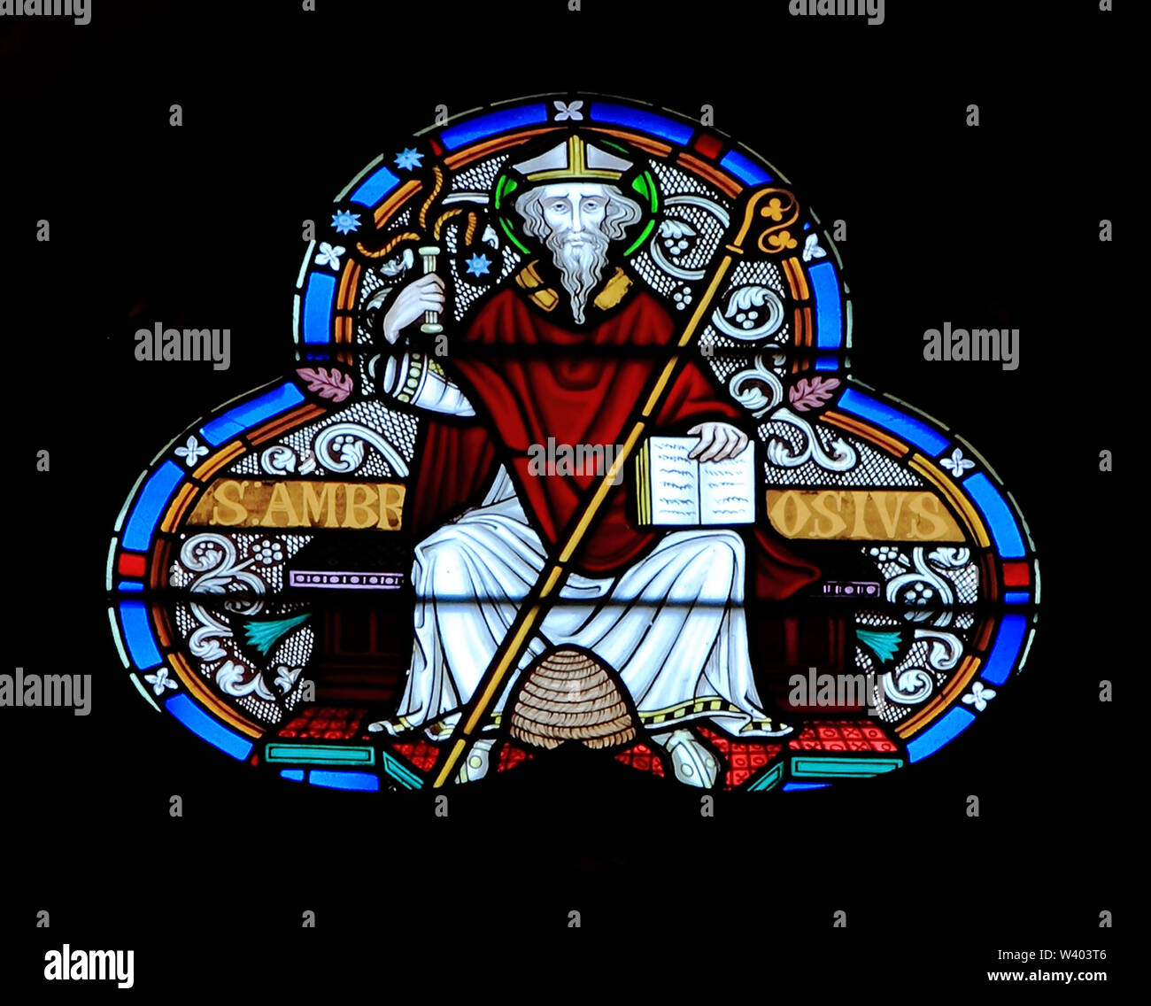 St. Ambrose, beehive at feet, scourge in hand, stained glass window, by