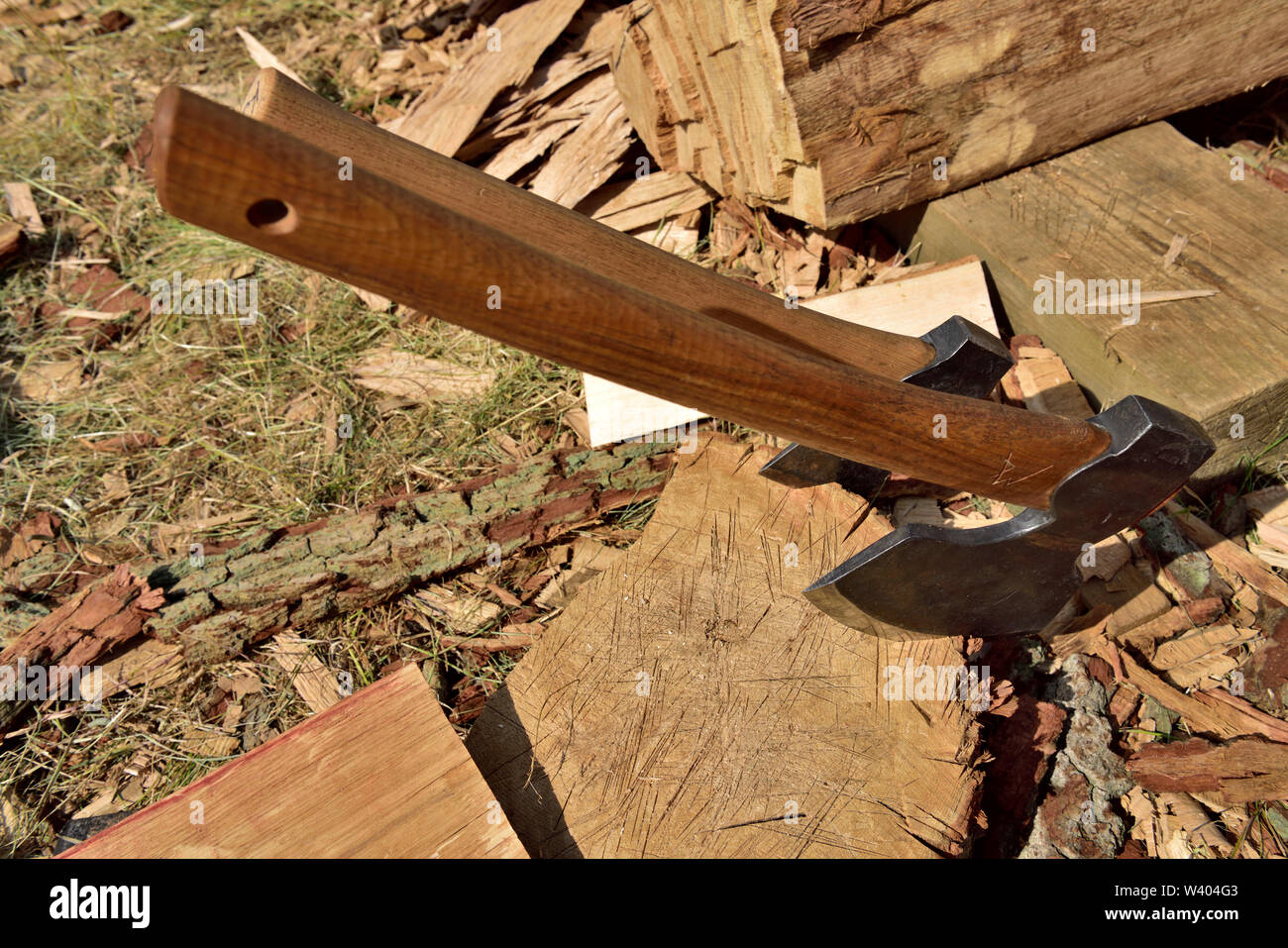 Two hand axes stuck in the end of a log Stock Photo
