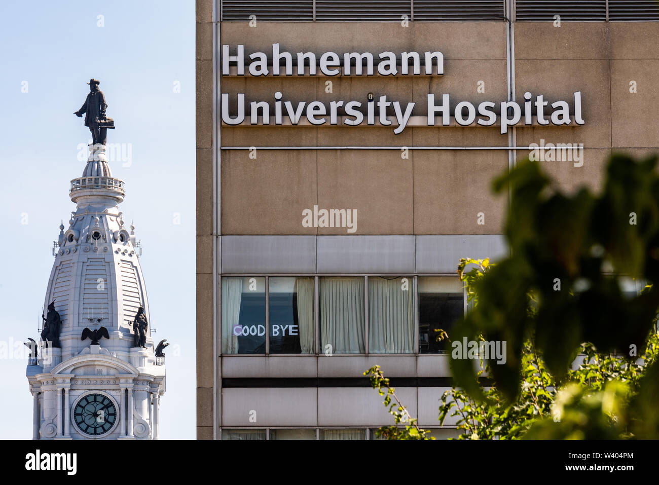 Philadelphia, Pennsylvania / USA. A view of Hahnemann University Hospital and Philadelphia City Hall shows a small sign declaring 'Good bye'. July 15, 2019. Photo Credit: Chris Baker Evens. Stock Photo